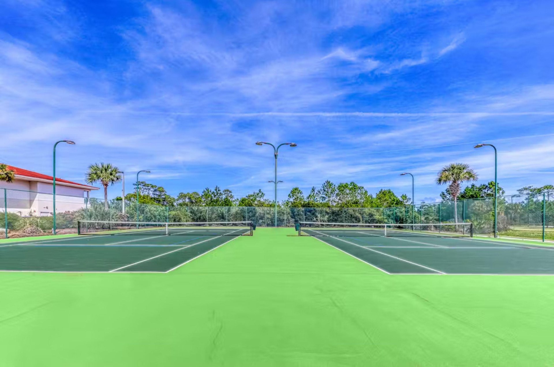 Two outdoor tennis courts at Indigo East and West