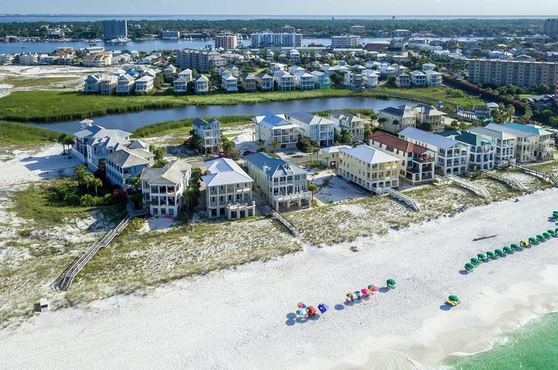 A birdseye view of some of the communitys singlefamily homes and condos nestled between the Gulf and Destin Harbor, with one of two lakes pictured.