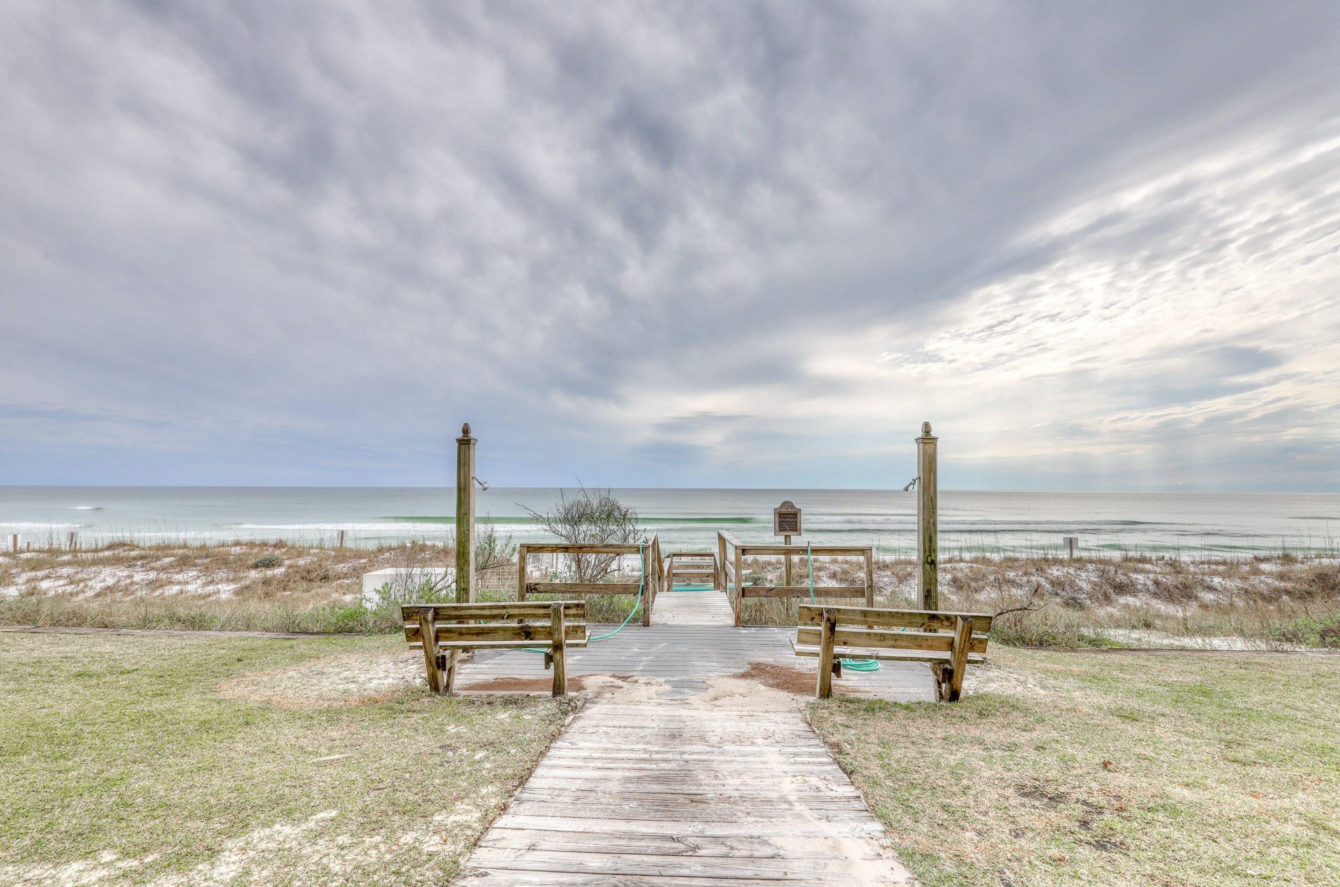 Crystal Villas boardwalk to and from the beach features two showers for rinsing off salt and sand.