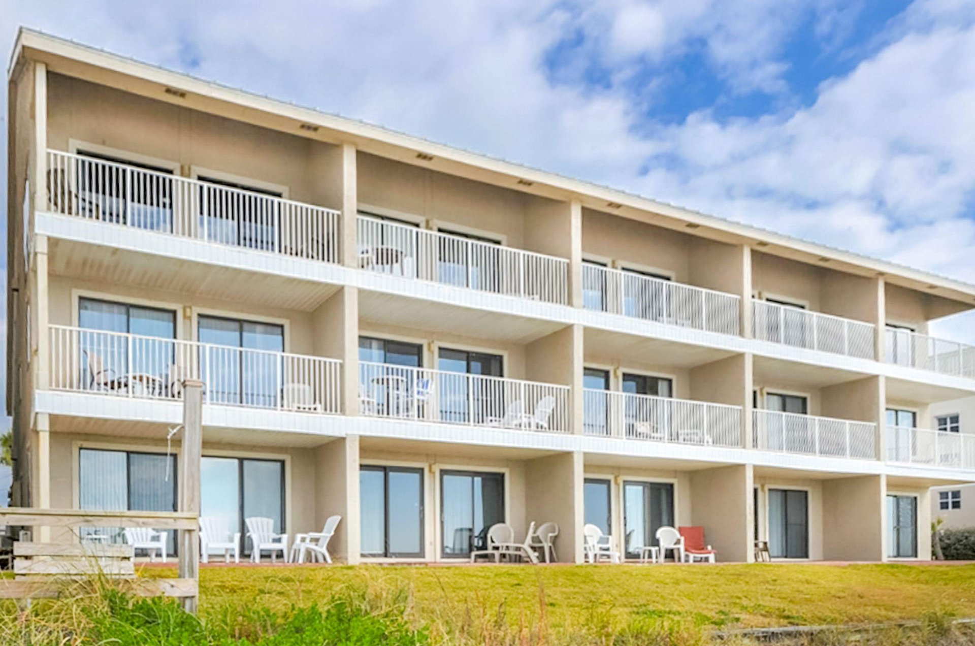 The units have either balconies or patios looking out over the coastline.