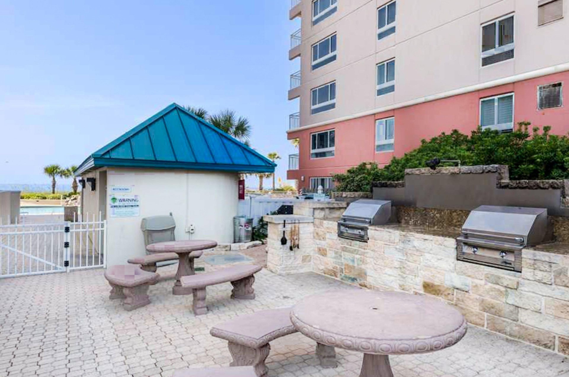 Grill and picnic area next to the gated pool and cabana