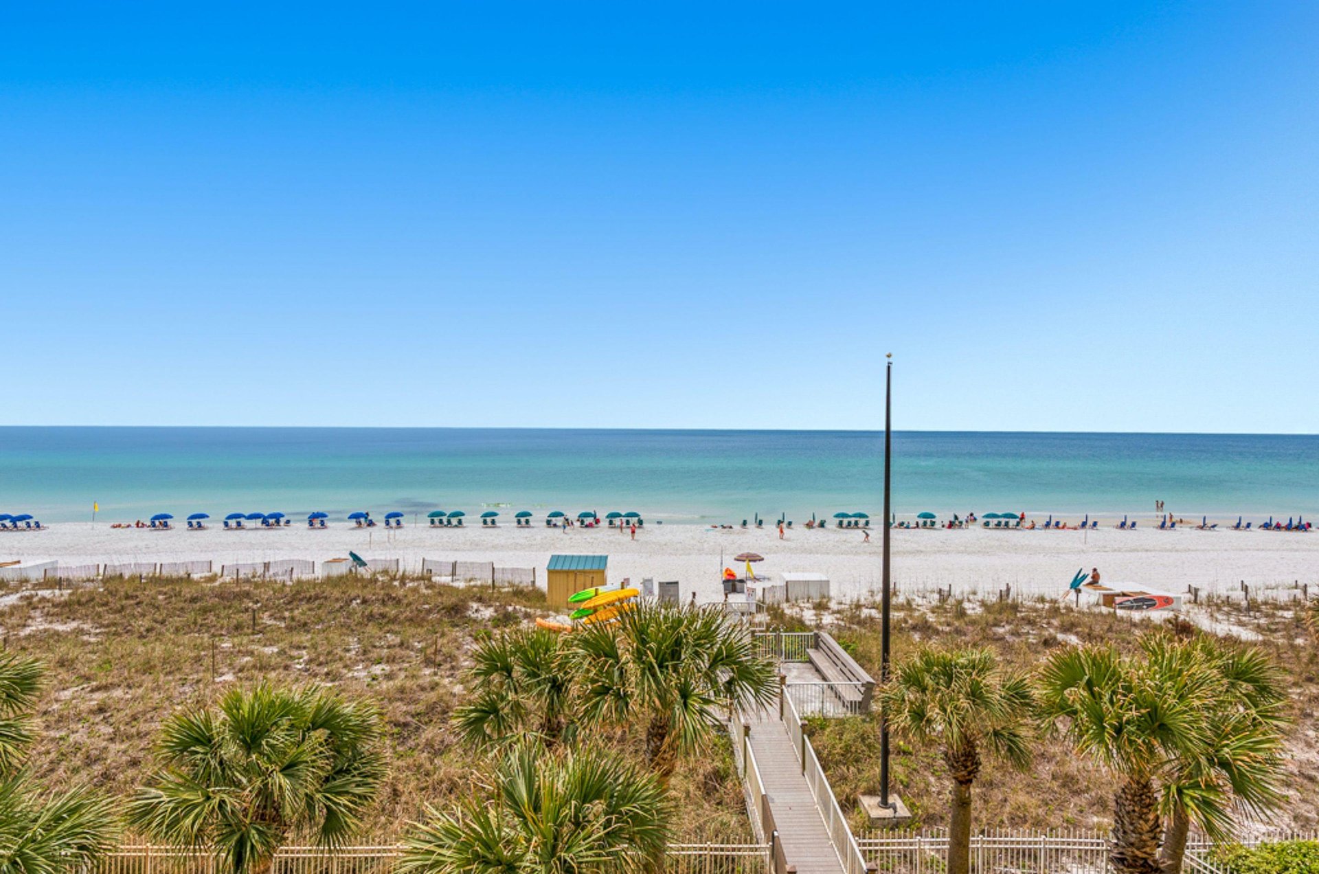 Jade Easts adjacent beach lined with loungers under umbrellas
