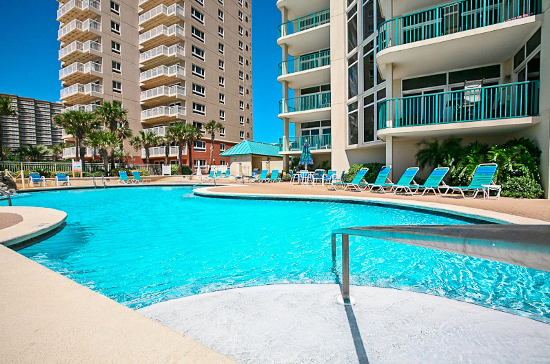 Community swimming pool, sundeck, and loungers