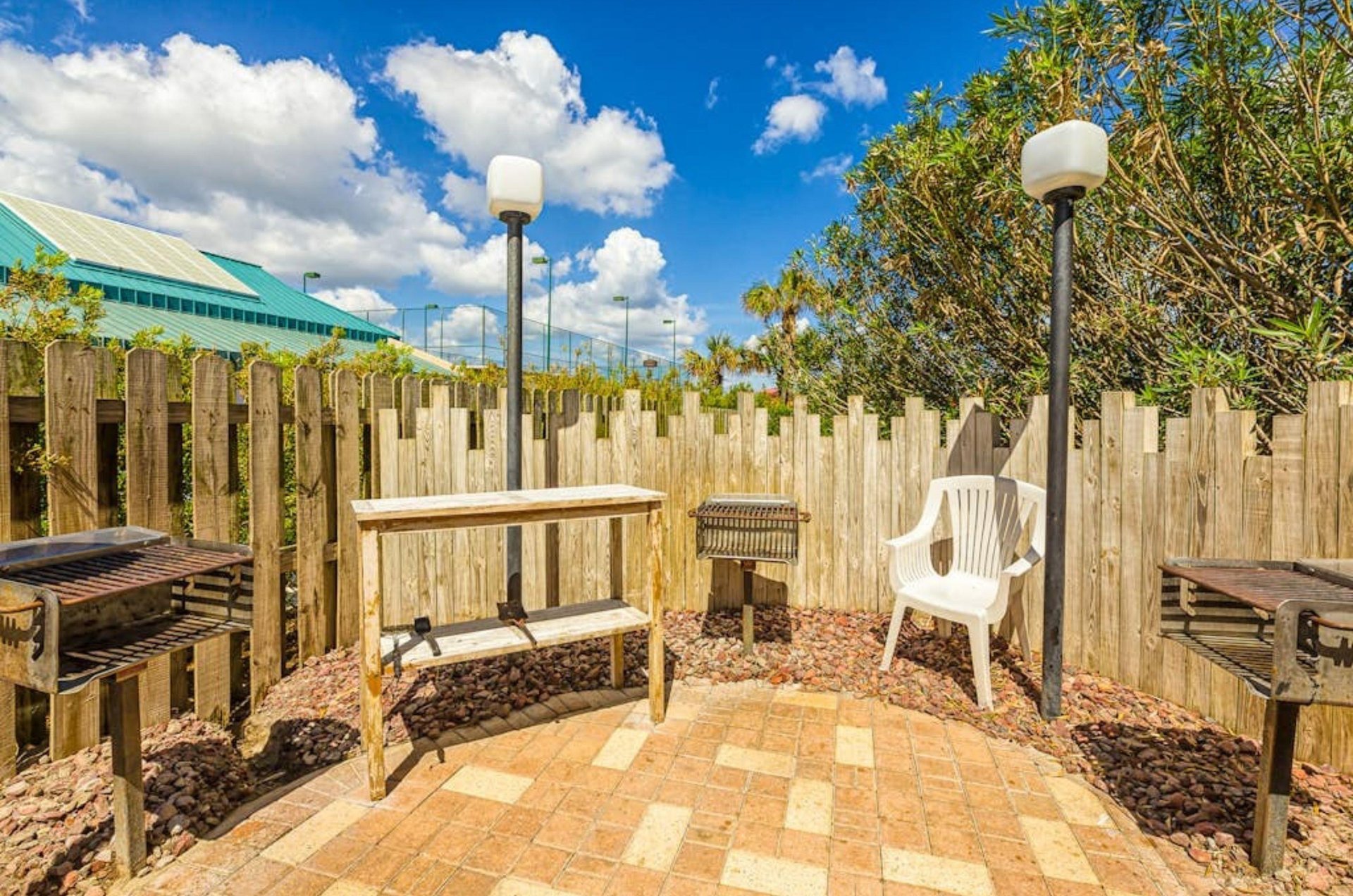 Patio with barbecue grills at Bluewater Condominiums