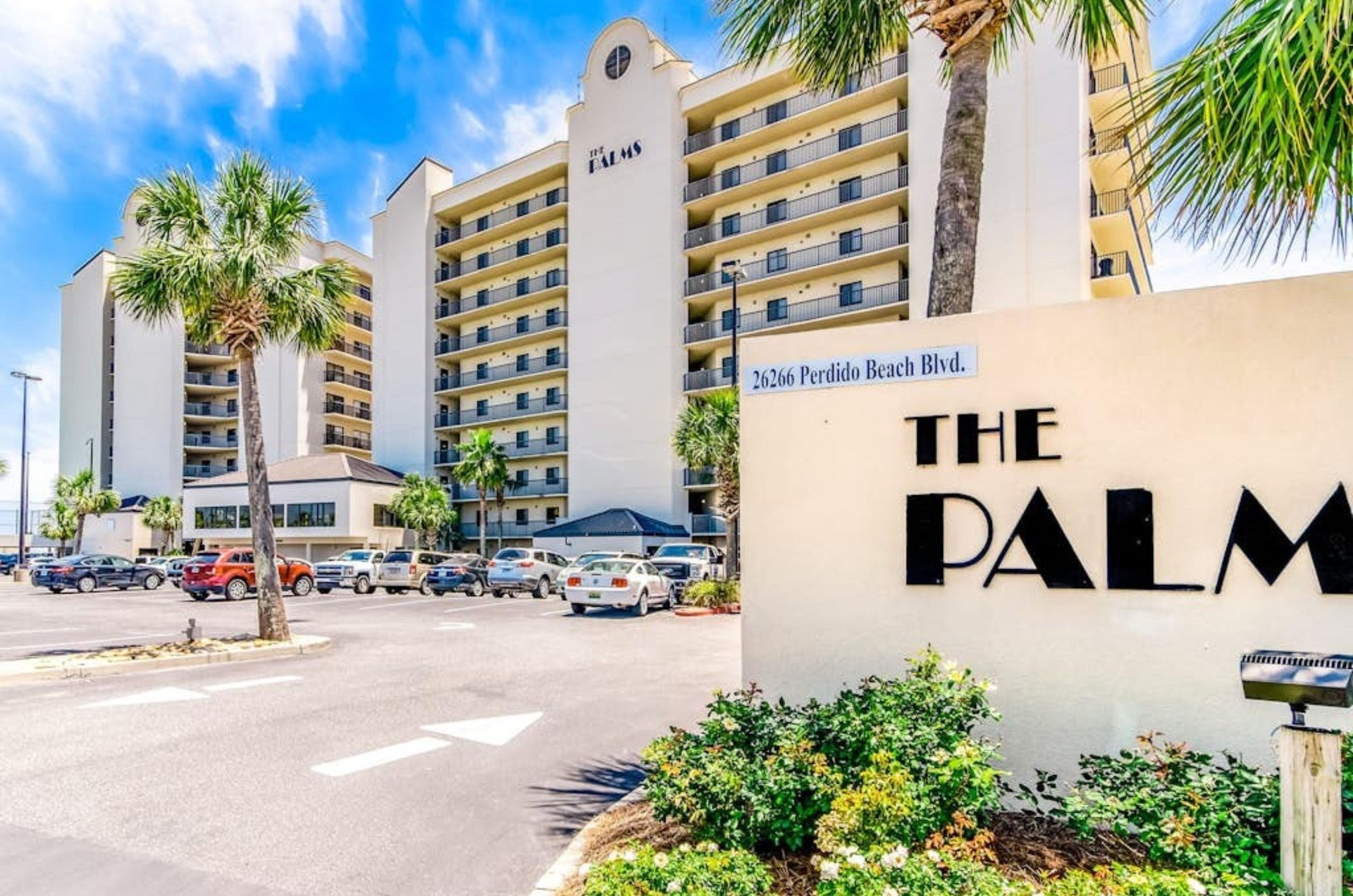 View from the street of the Palms and the entry sign in Orange Beach Alabama