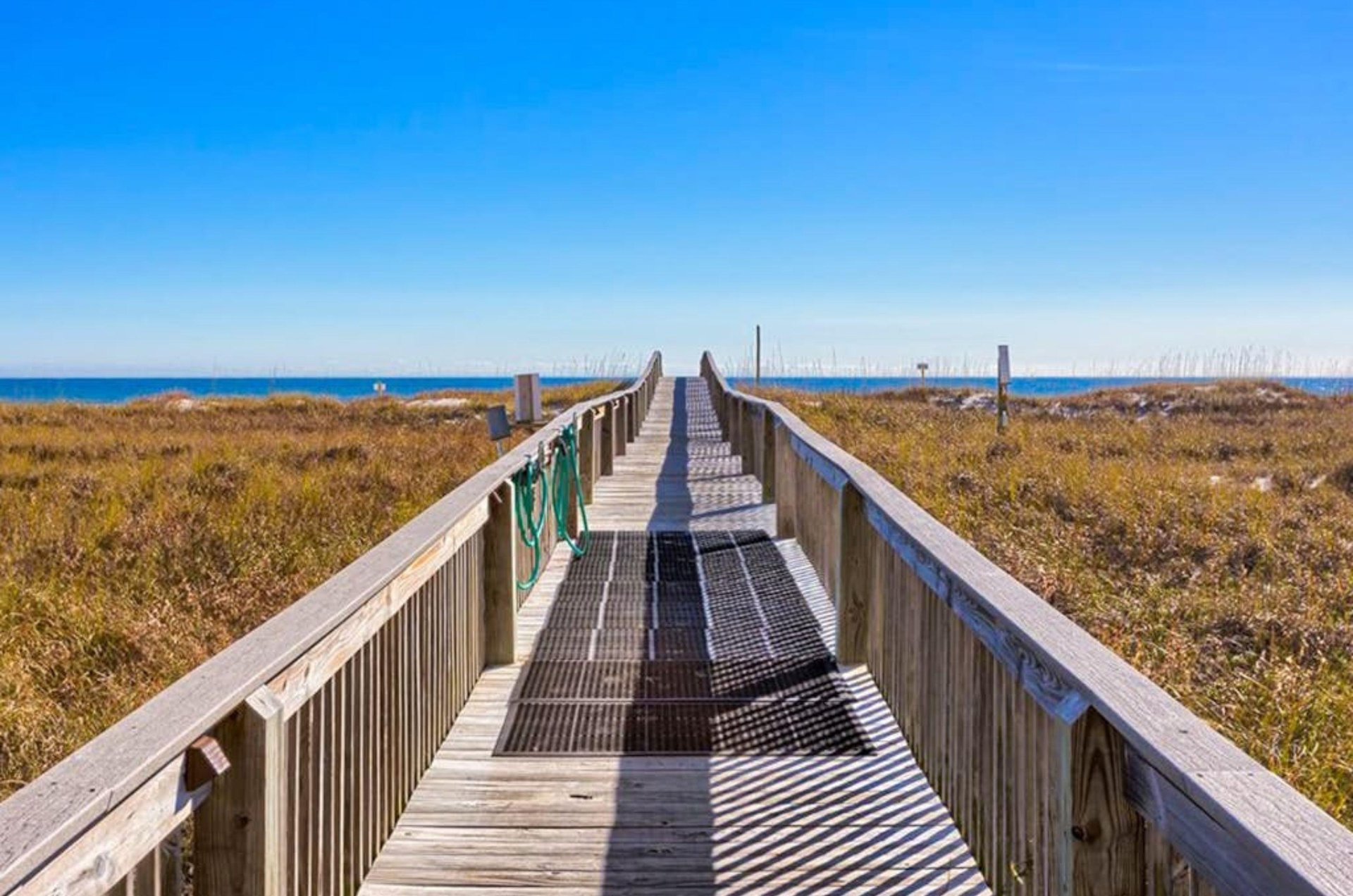 A wooden boardwalk leading to the beach at Tidewater in Orange Beach Alabama