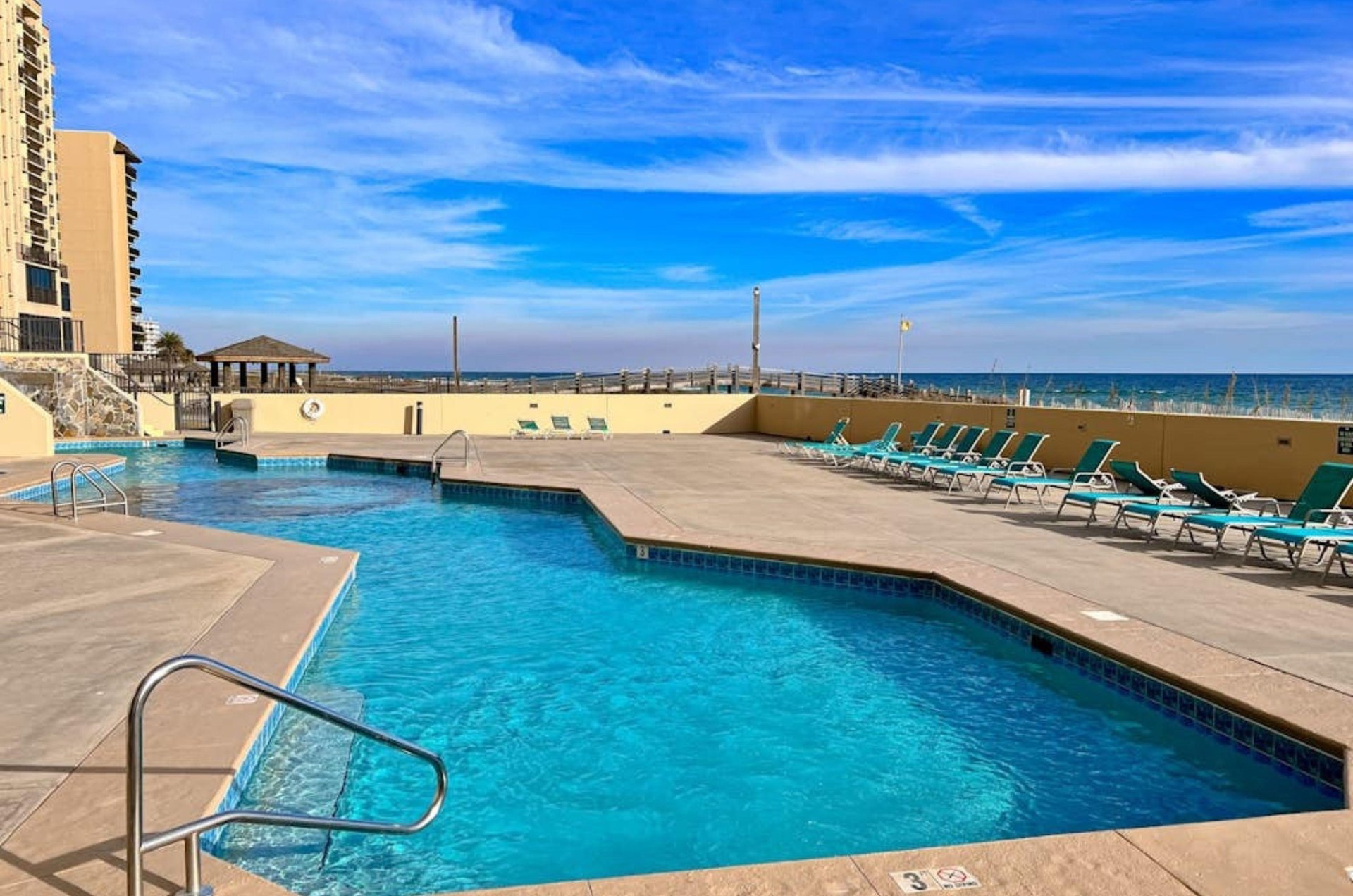 The outdoor swimming pool next to the beach at Phoenix II in Orange Beach Alabama