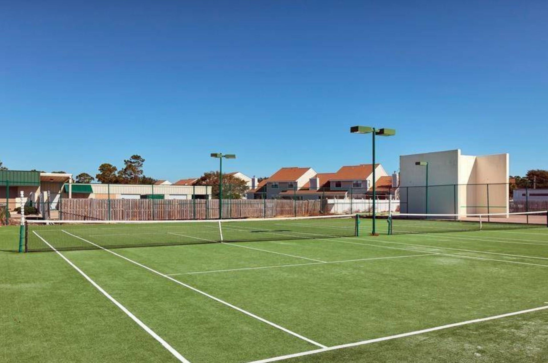 The outdoor tennis court at Summer House on Romar Beach