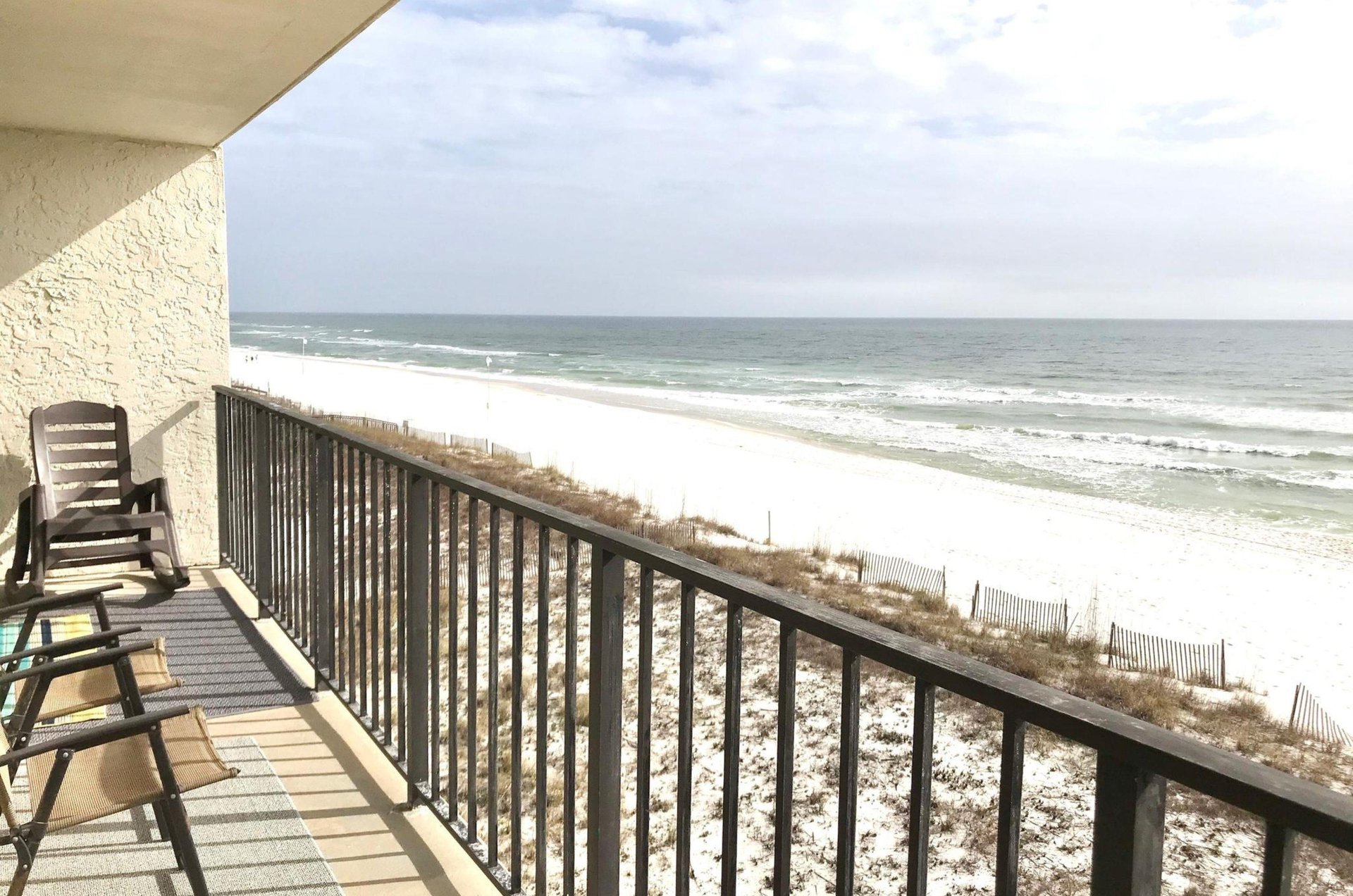 A private balcony with chairs overlooking the Gulf of Mexico at Lei Lani
