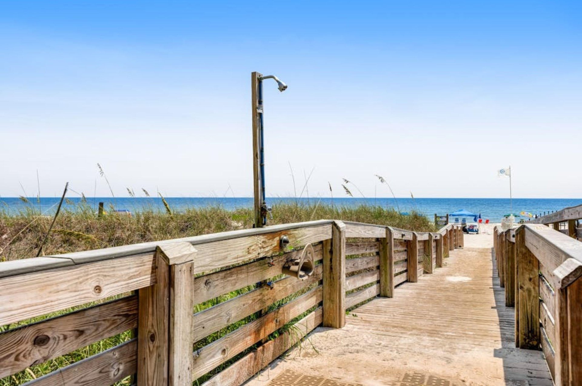 The outdoor shower on a wooden boardwalk at the Enclave