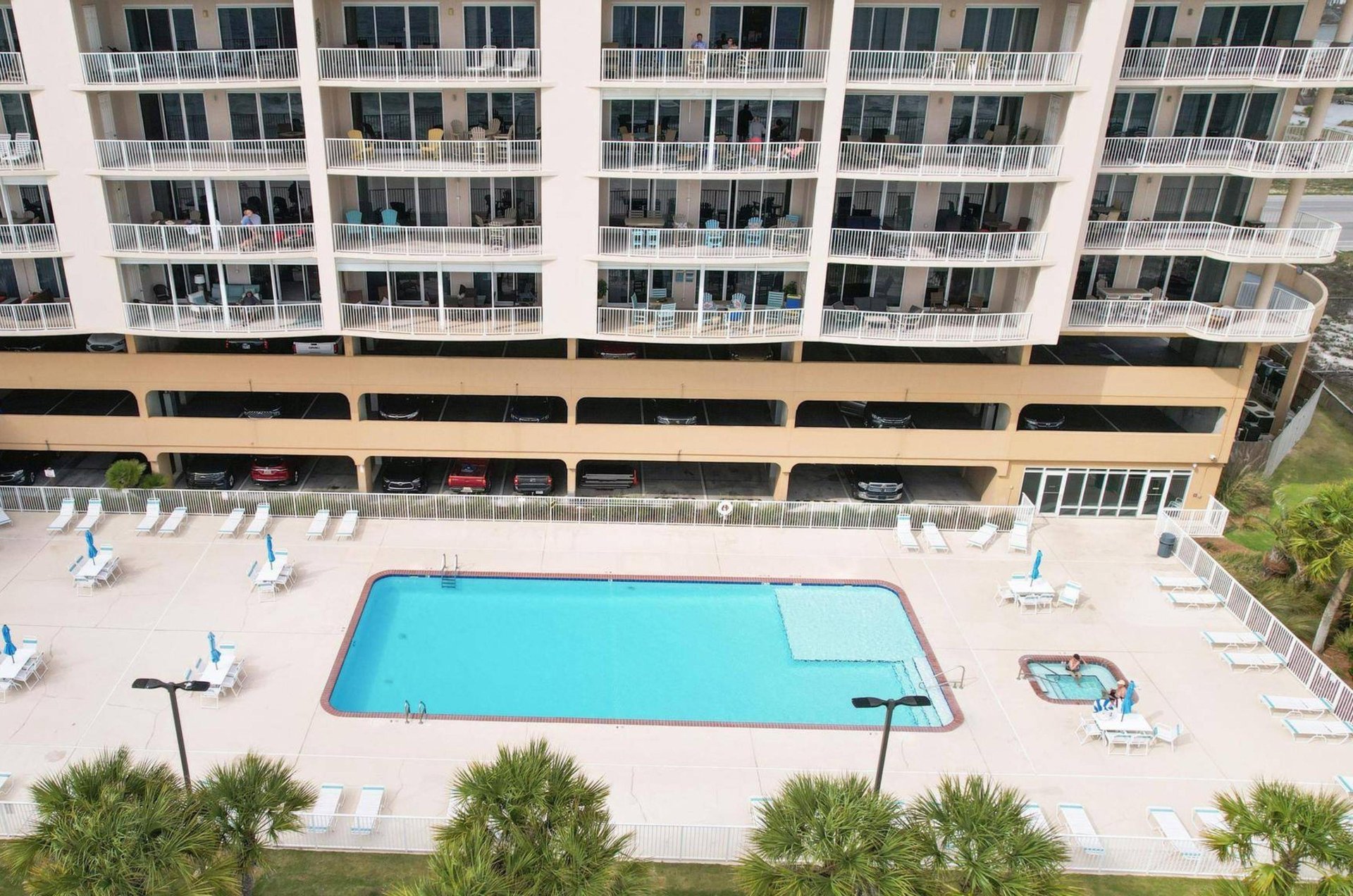 Aerial view of the outdoor swimming pool and hot tub at Regency Isle in Orange Beach Alabama
