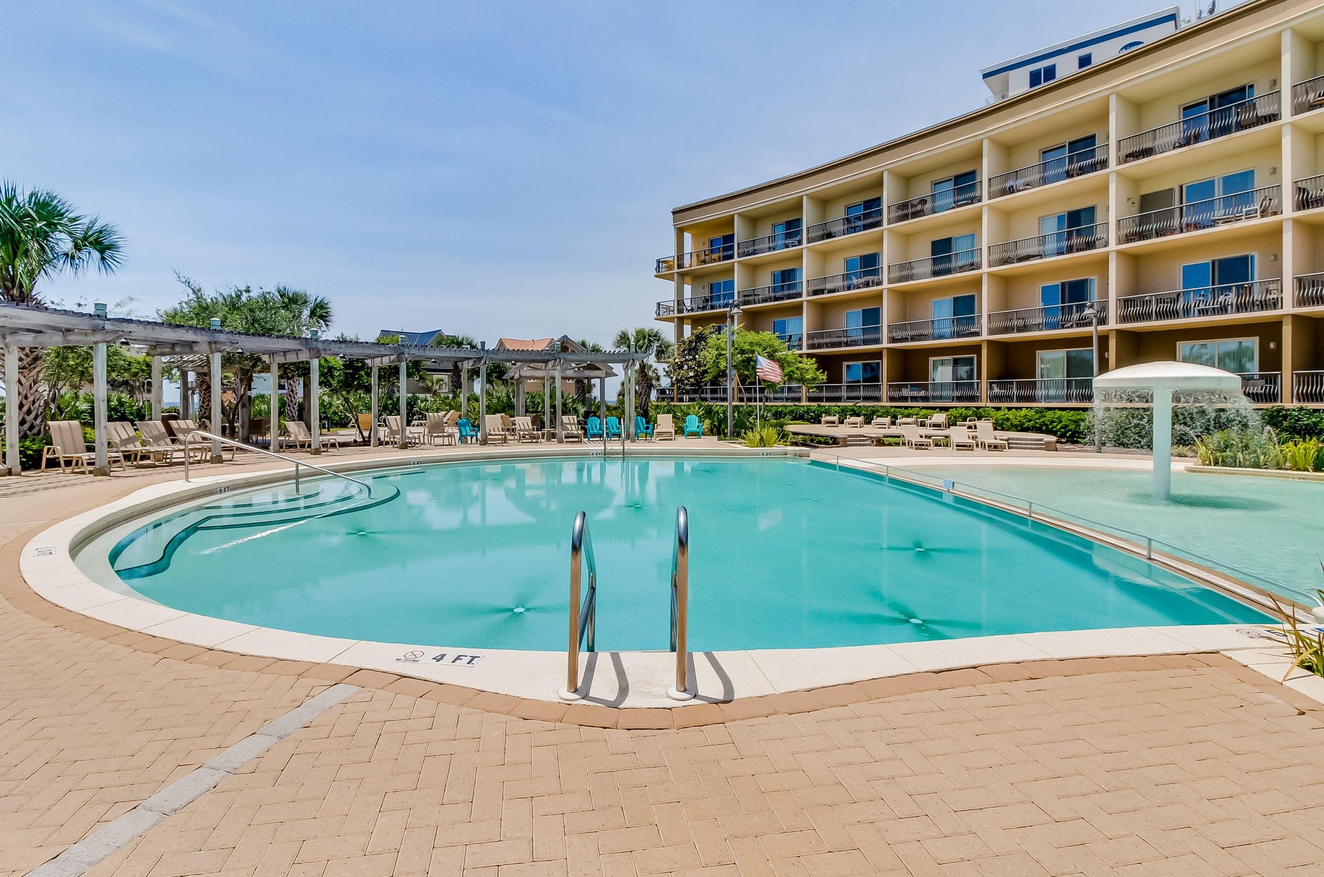 Balconies overlook the shimmering swimming pool.