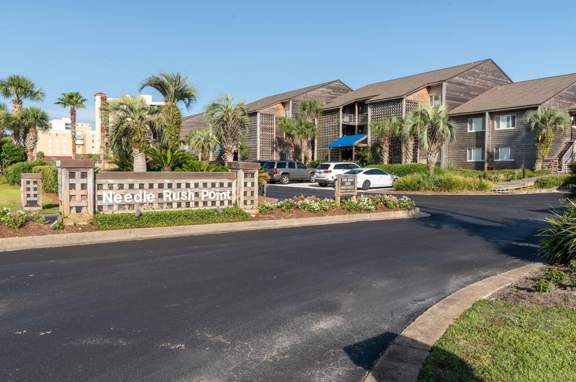 The streetside exterior of Needle Rush Point and the propertys entry sign