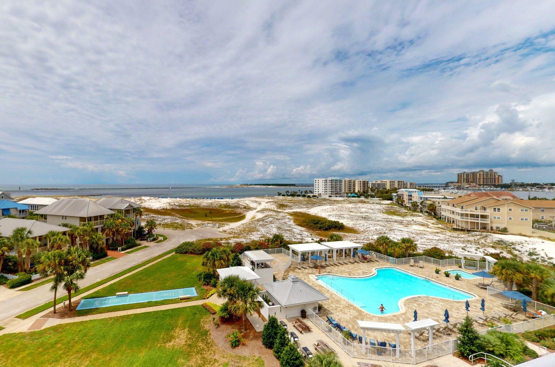 Scenic view of the community pool, shuffleboard and East Pass beyond