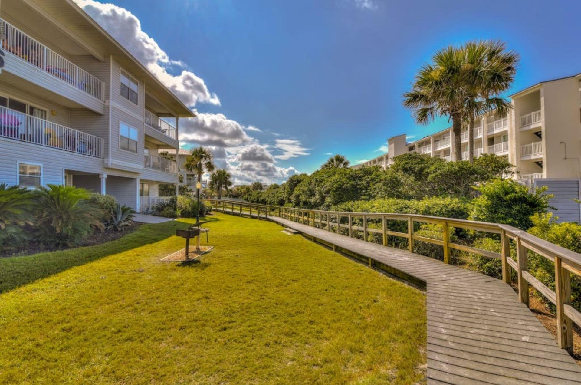 A wooden boardwalk between the townhomes at Beachside Villas in Seagrove Beach Florida