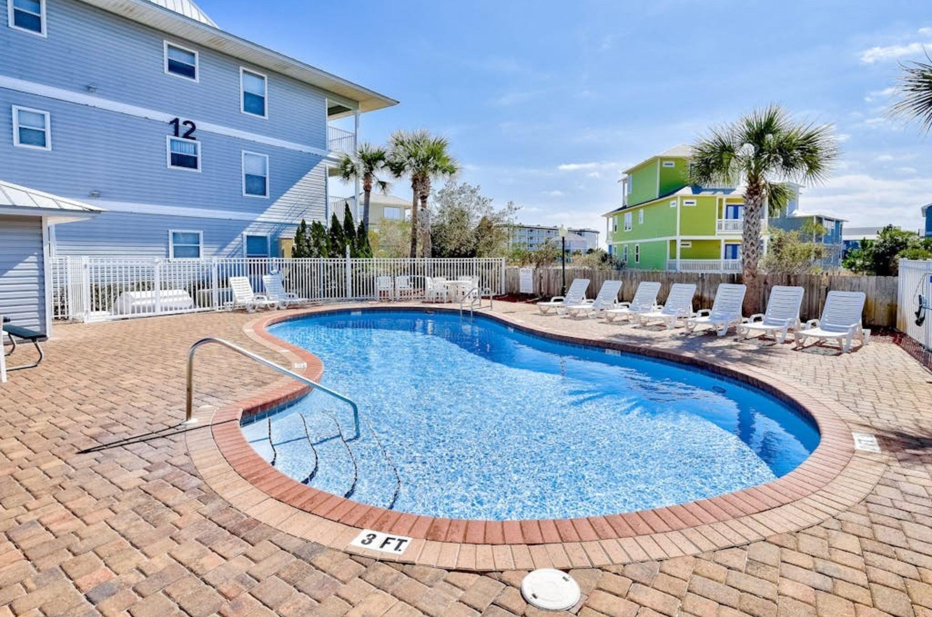 One of the outdoor pools and pool deck with lounge chairs in front of Beachside Villas in Seagrove Beach Florida