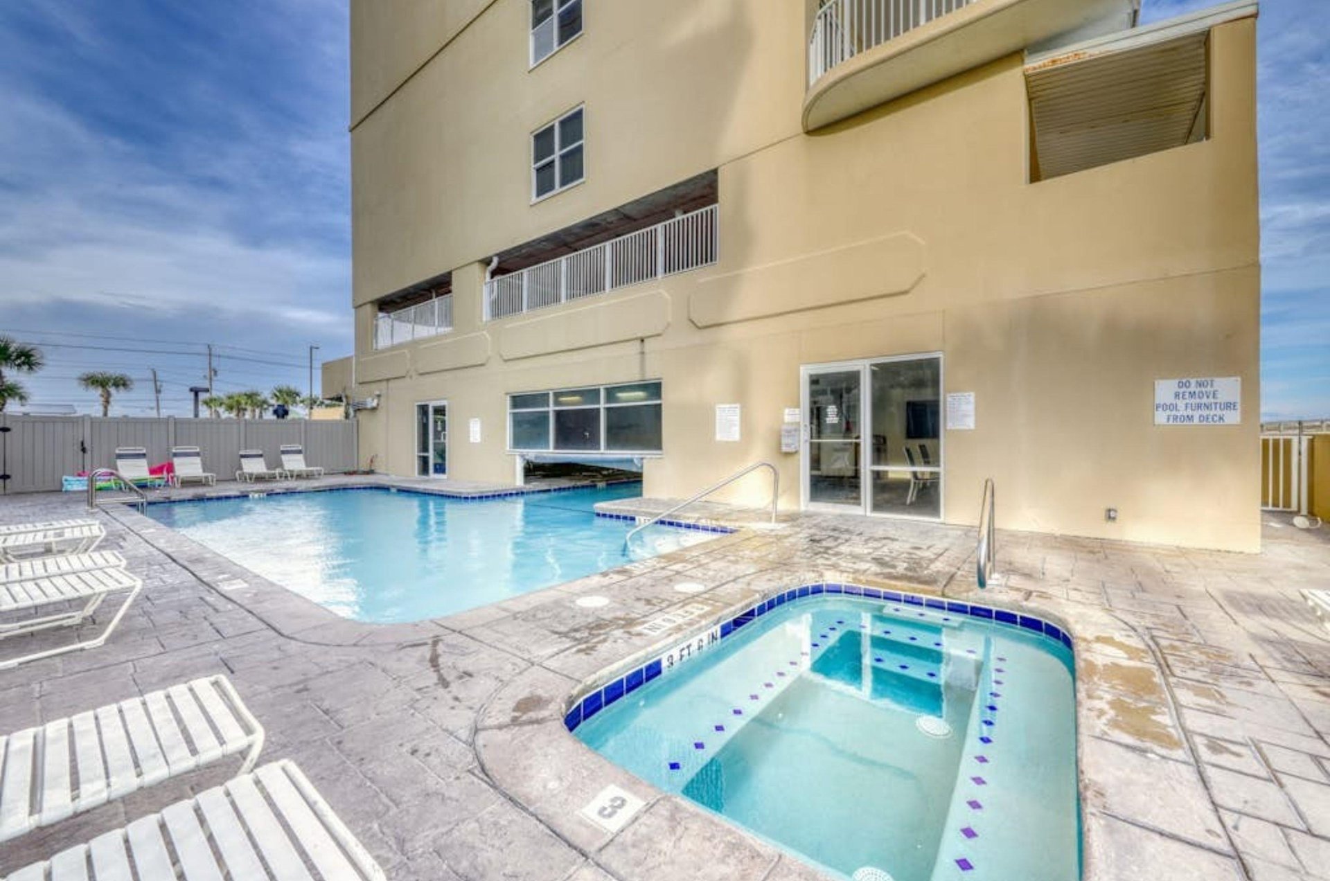 The indooroutdoor pool and outdoor hot tub in front of Island Royale in Gulf Shores Alabama