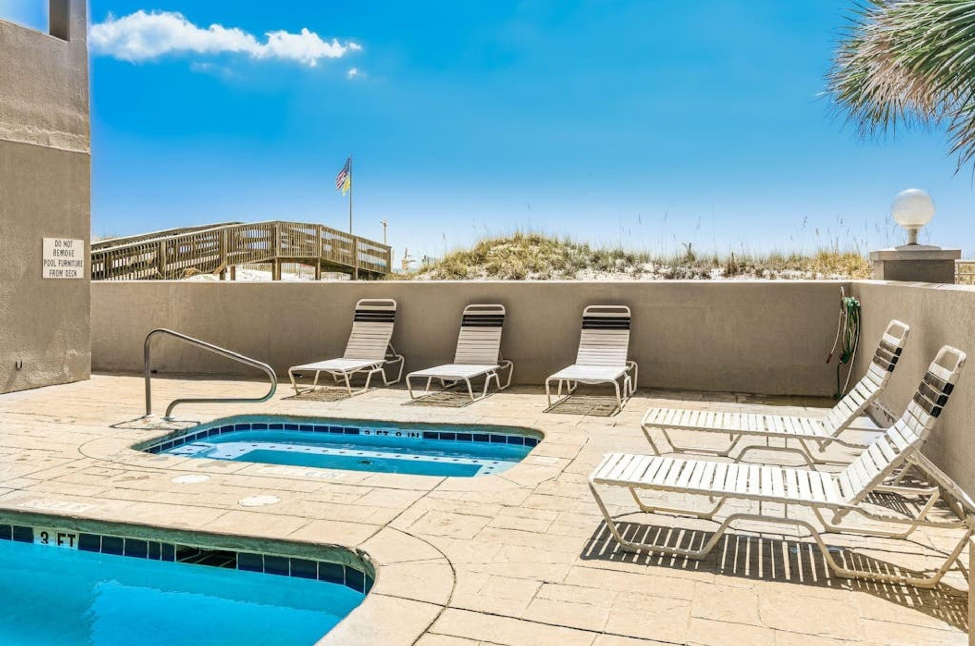 Lounge chairs on the pool deck next to the beachside pools at Island Royale in Gulf Shores Alabama
