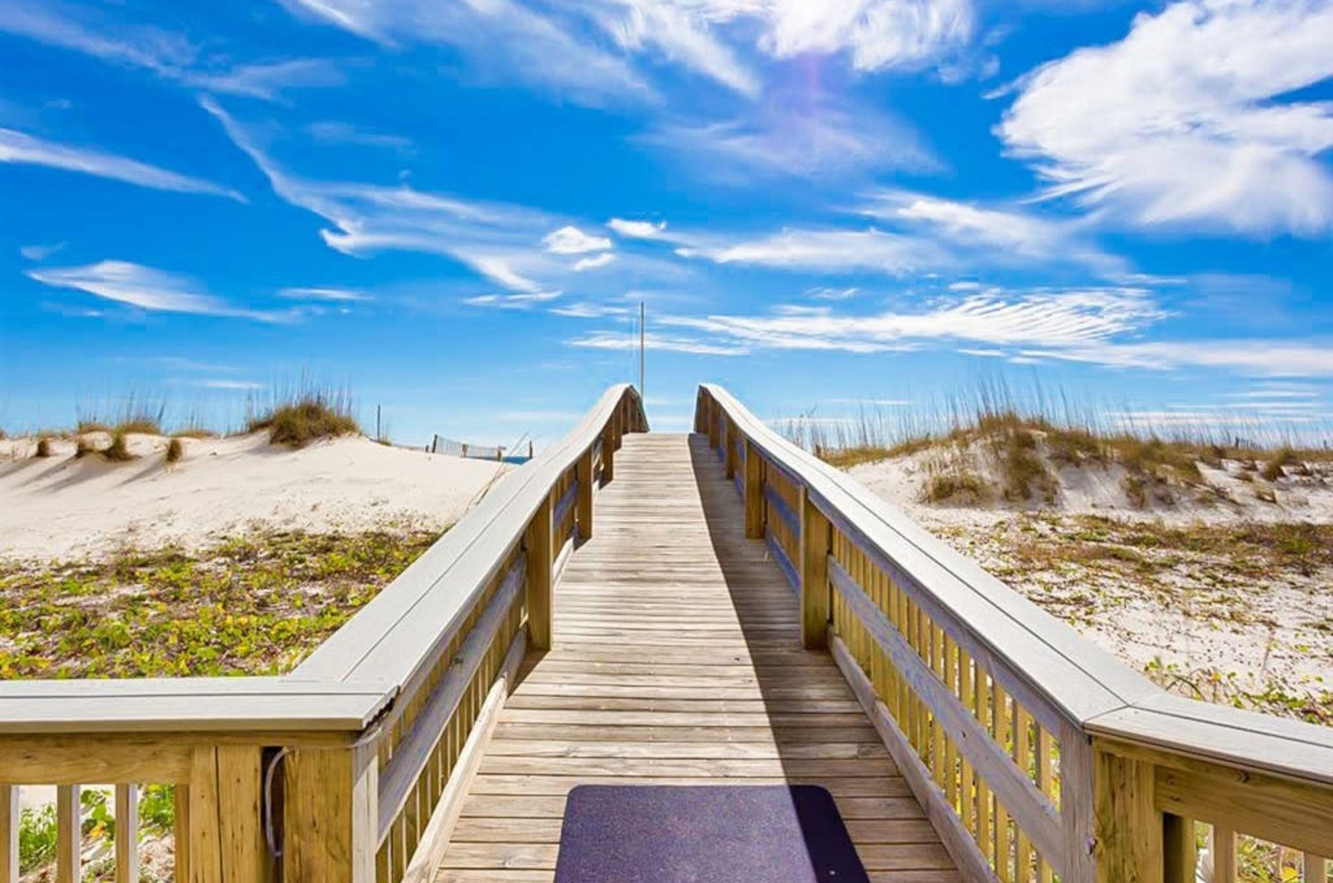 A wooden boardwalk leading to the beach at Island Royale in Gulf Shores Alabama