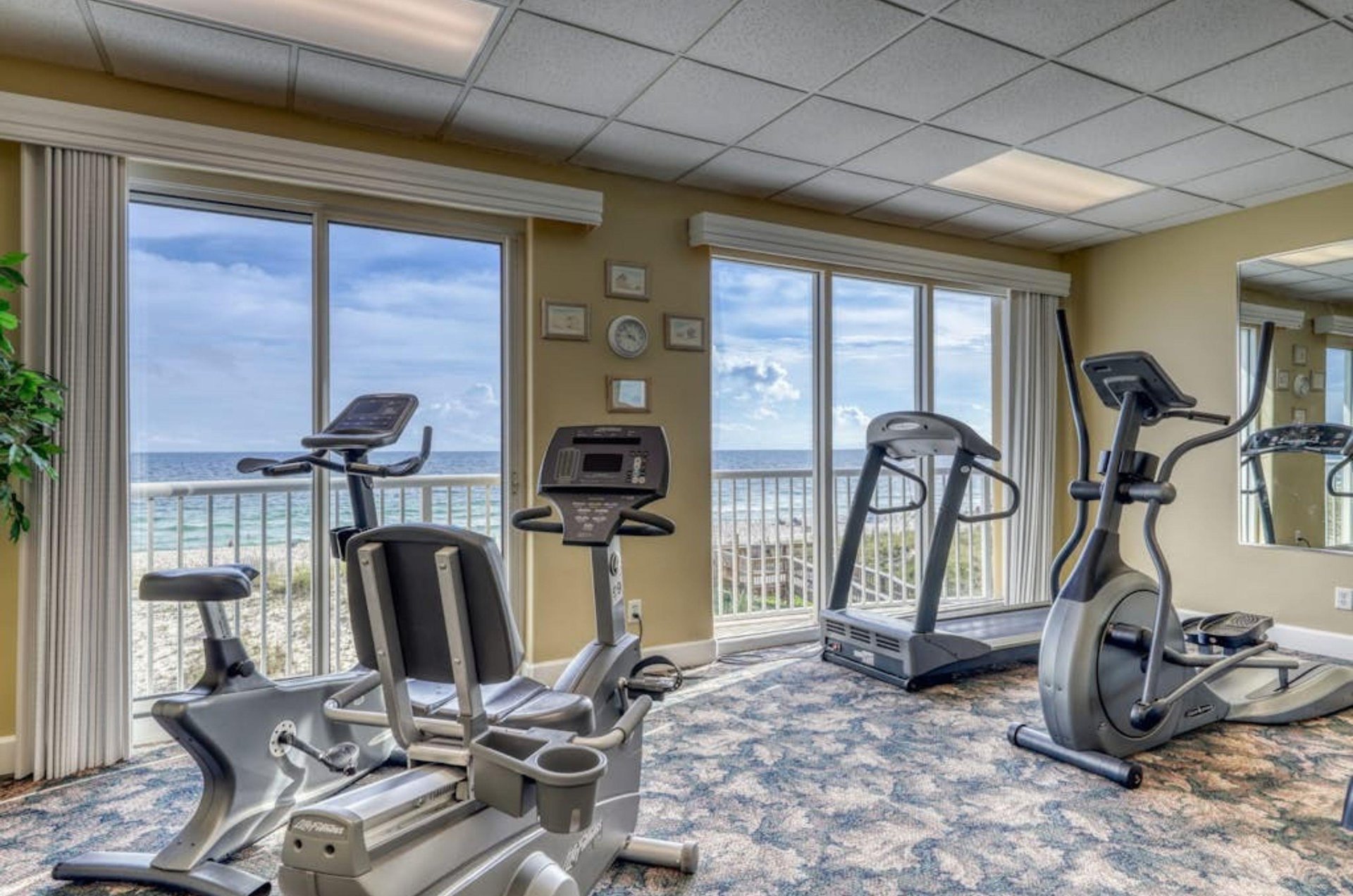 Cardio equipment in the gym at Island Royale next to Gulffacing windows