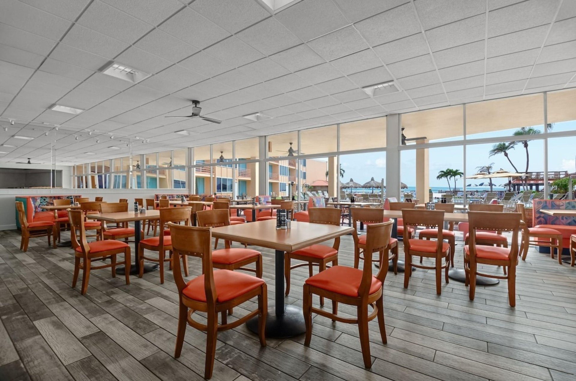 Dining tables and chairs in Dolphin Beach Resorts restaurant
