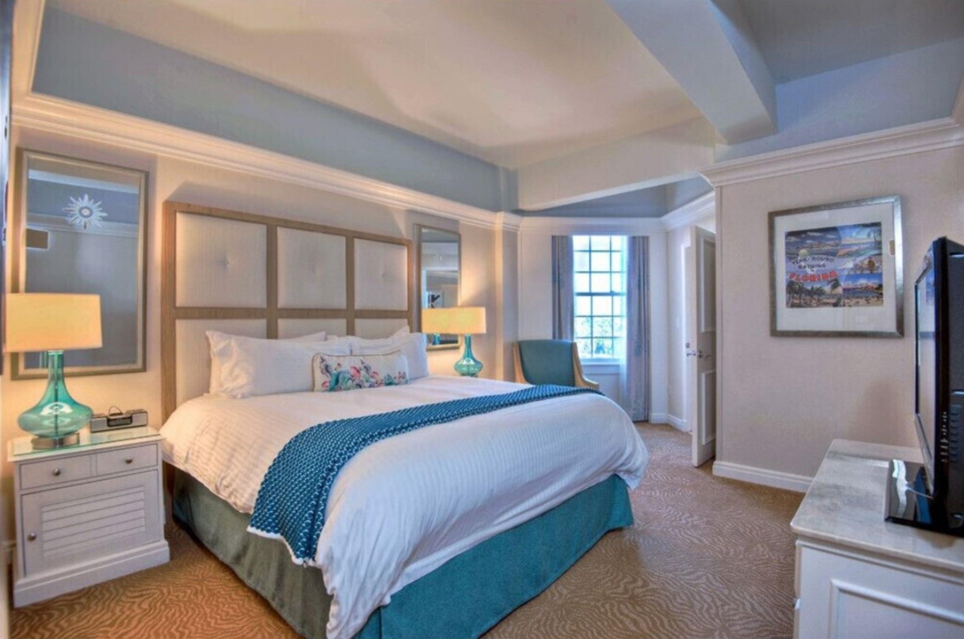 This bedroom is cozy, beautiful and inviting.