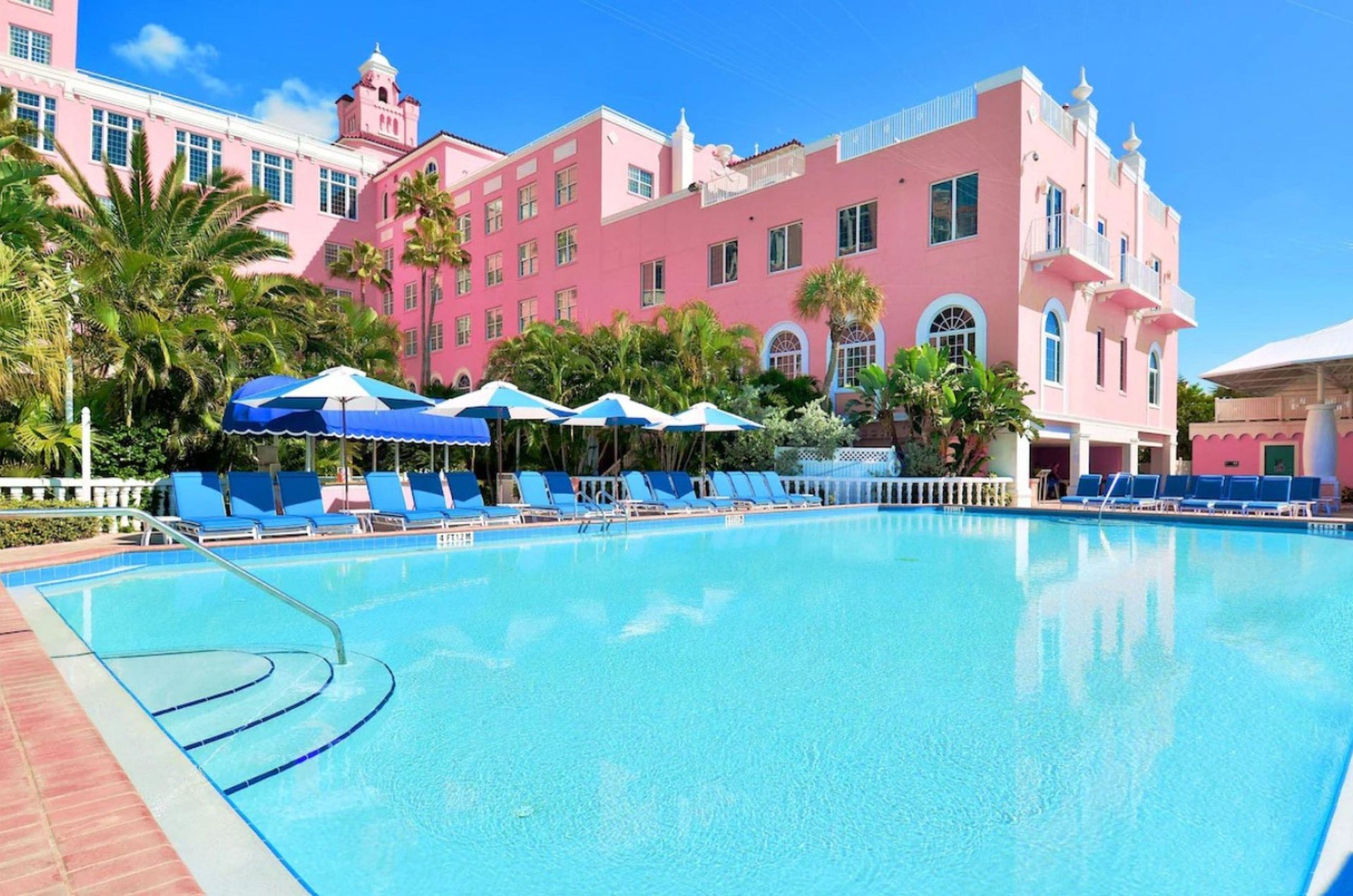 This swimming pool and sundeck at the Don Cesar glistens under a blue bird sky on a sunny day.