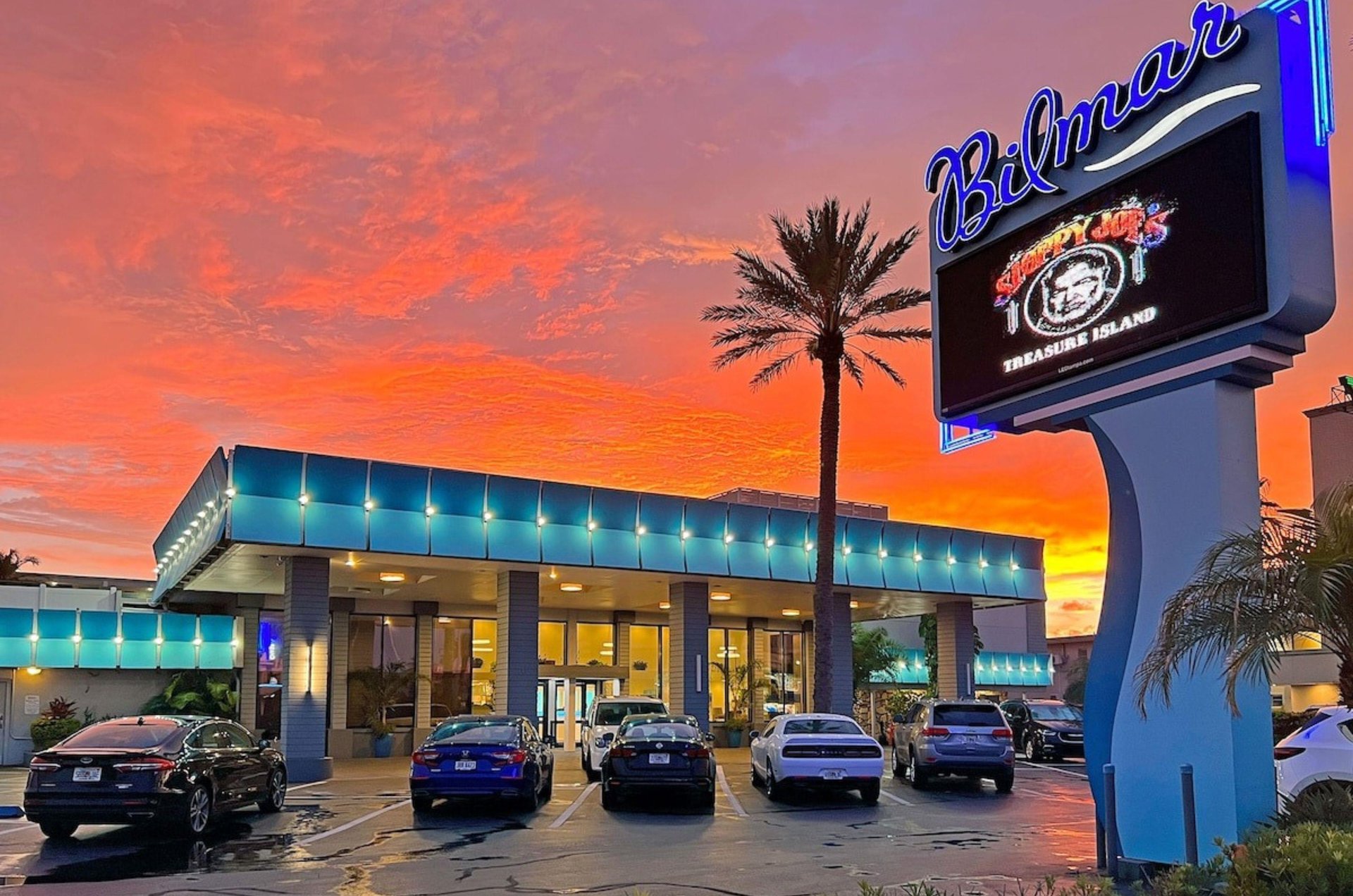 View from the street of the exterior of and parking lot at Bilmar Beach Resort
