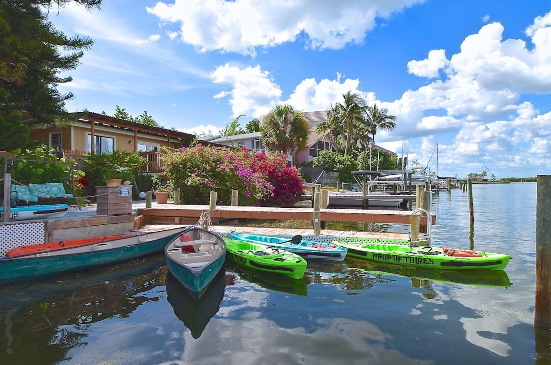 The wooden deck on the water with kayaks at the Inn at Turtle Beach in Siesta Key Florida