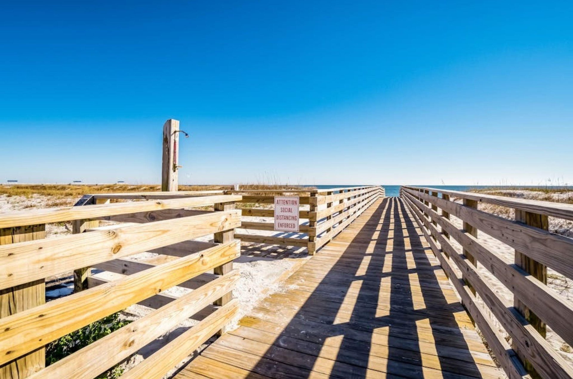 A wooden boardwalk leading to the beach across the street from Grand Caribbean