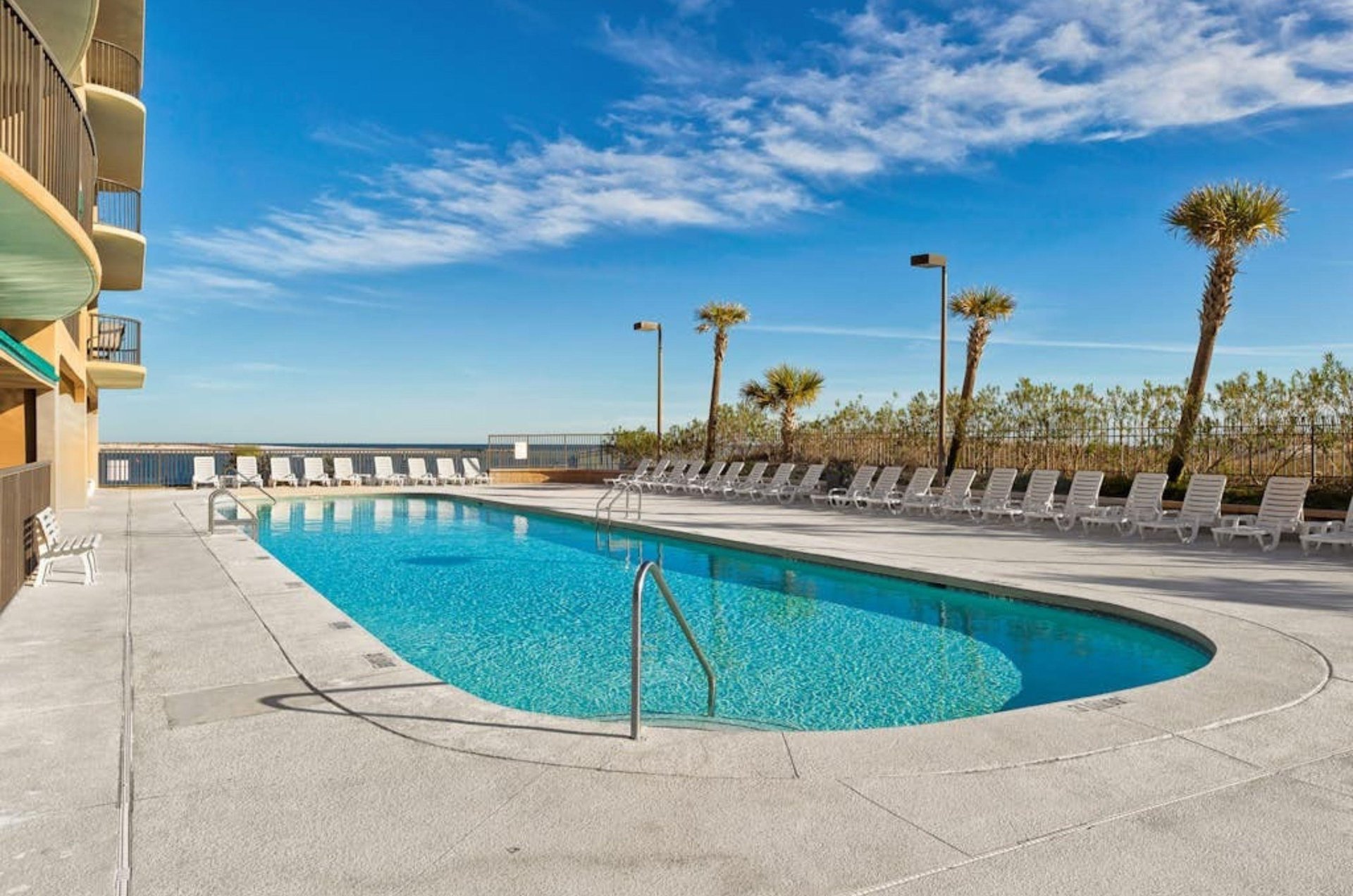 The outdoors swimming pool next to the beach at Grand Pointe in Orange Beach Alabama