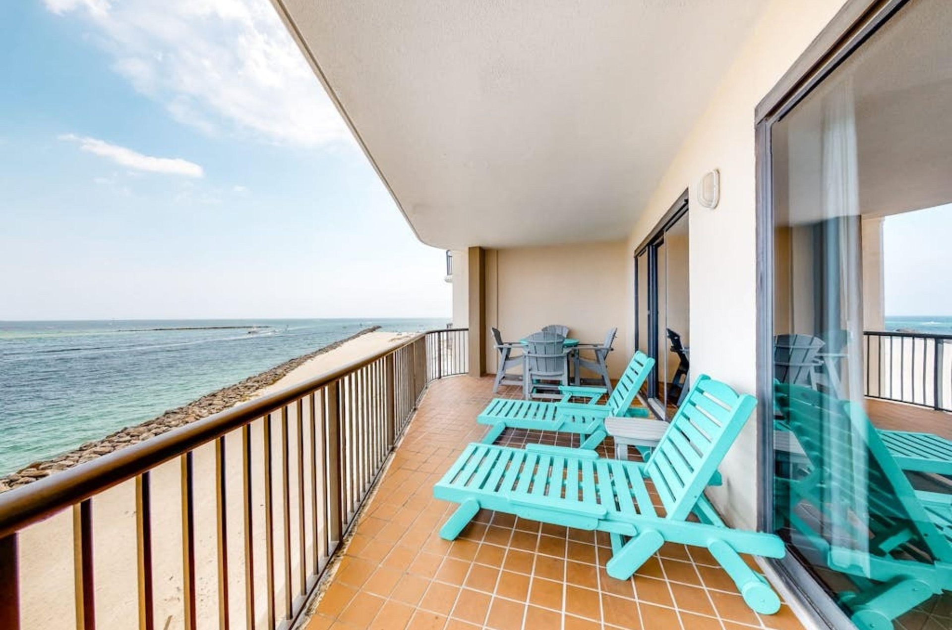 A private balcony with lounge chairs on a private balcony at Grand Pointe