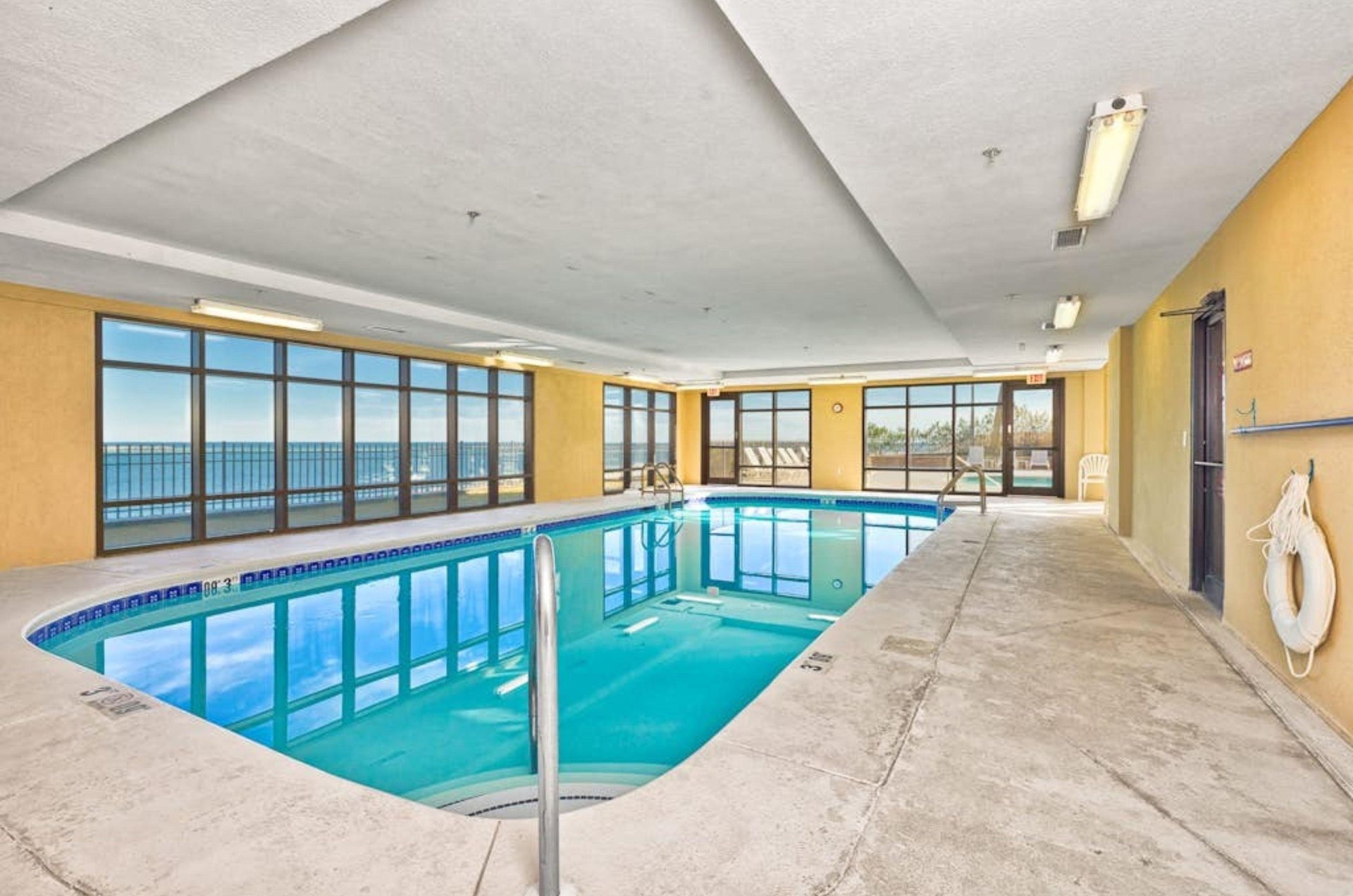 The indoor swimming pool next to windows at Grand Pointe in Orange Beach Alabama