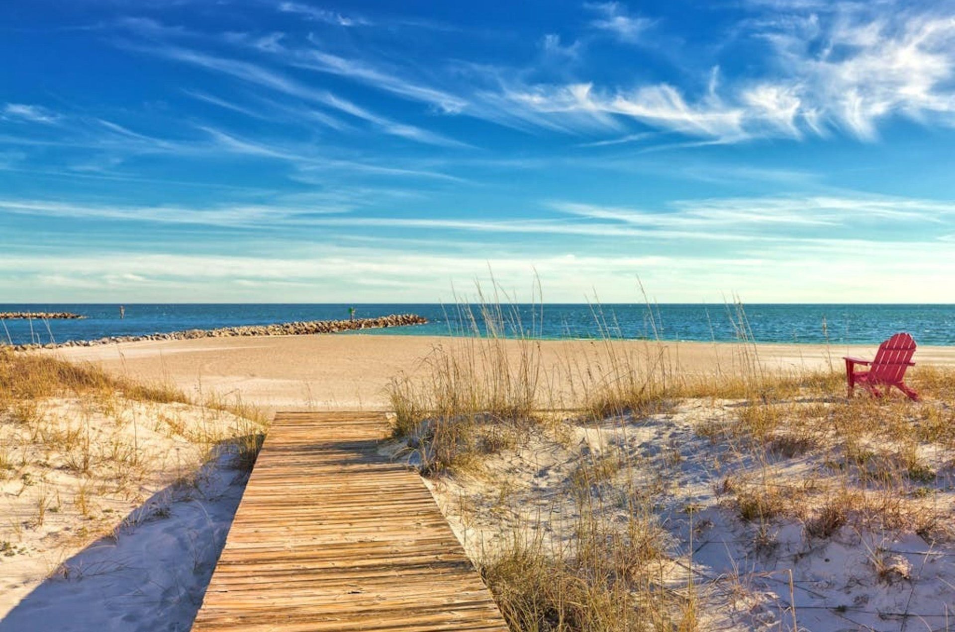 A wooden boardwalk leading towards the Gulf at Grand Pointe in Orange Beach Alabama