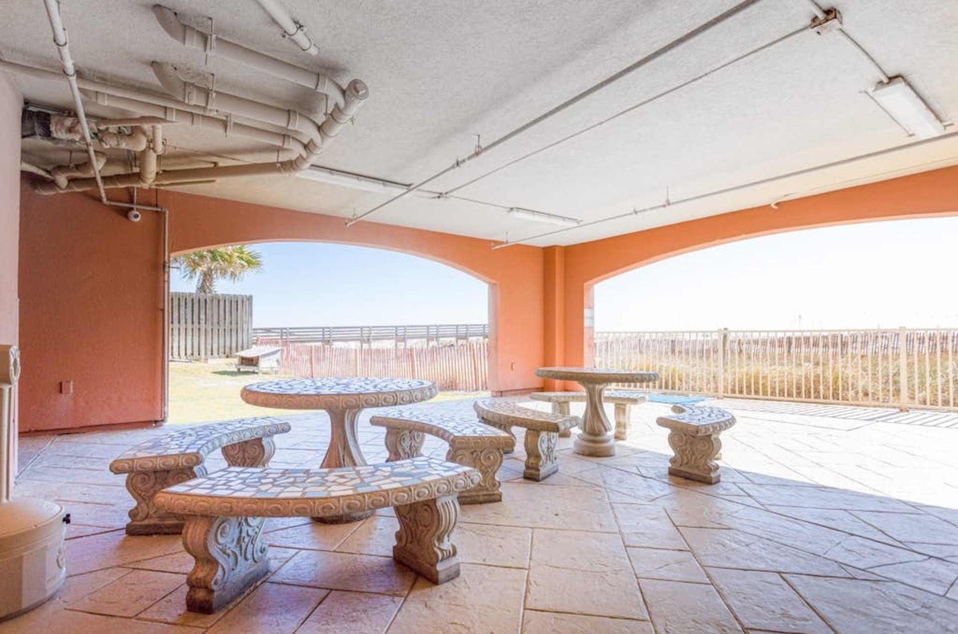 Stone picnic tables on a covered patio at Harbour Place in Orange Beach Alabama