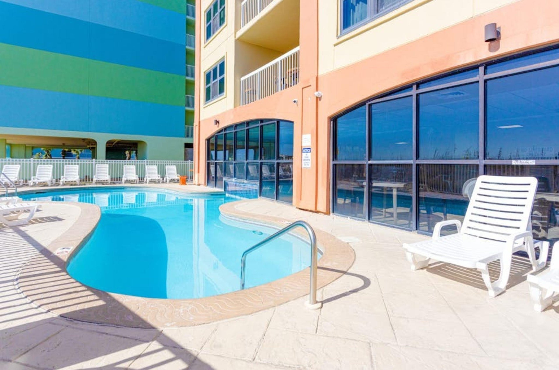 The outdoor pool and pool deck in front of Harbour Place in Orange Beach Alabama