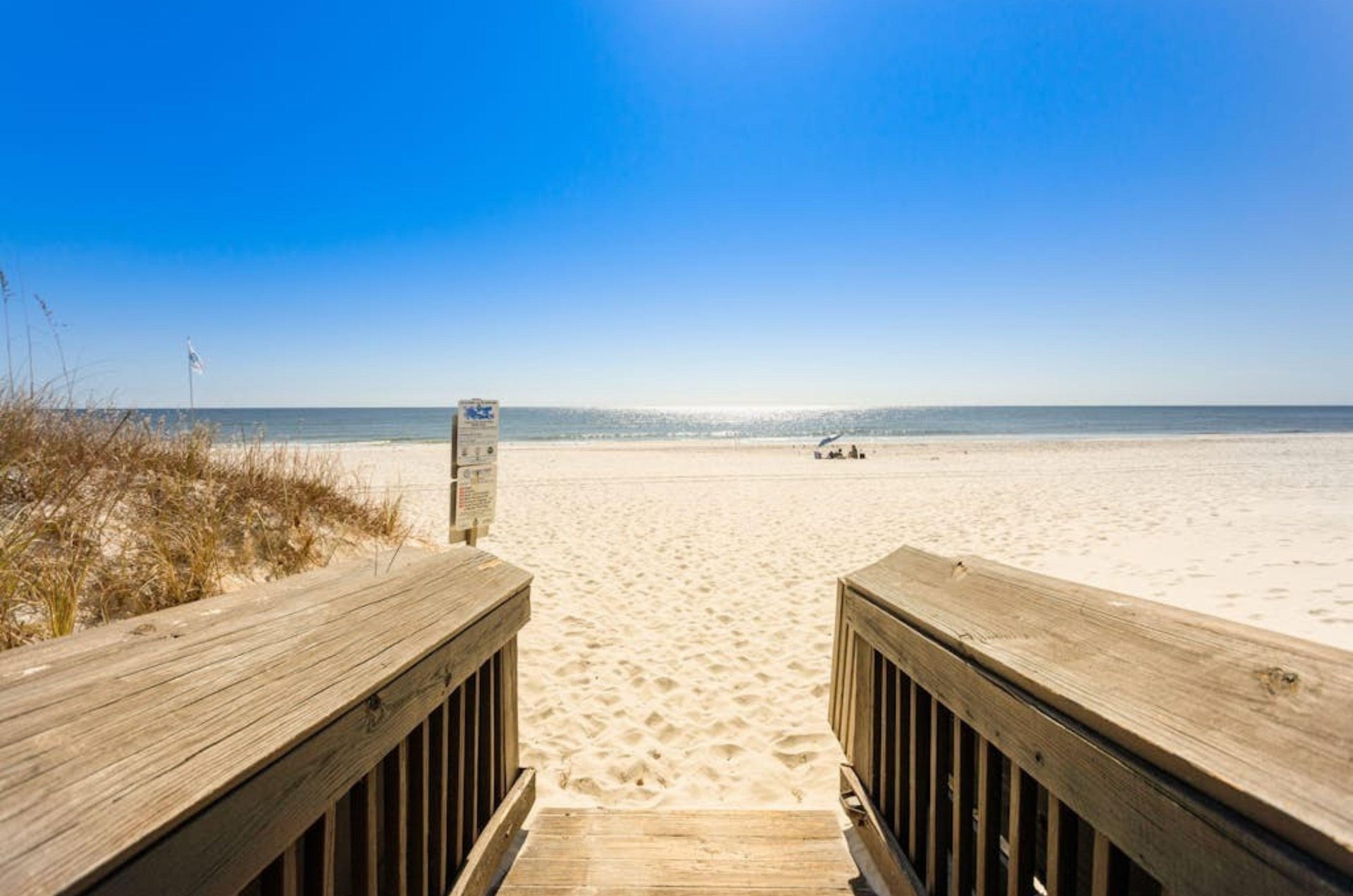 A wooden boardwalk leading to the beach at Harbour Place