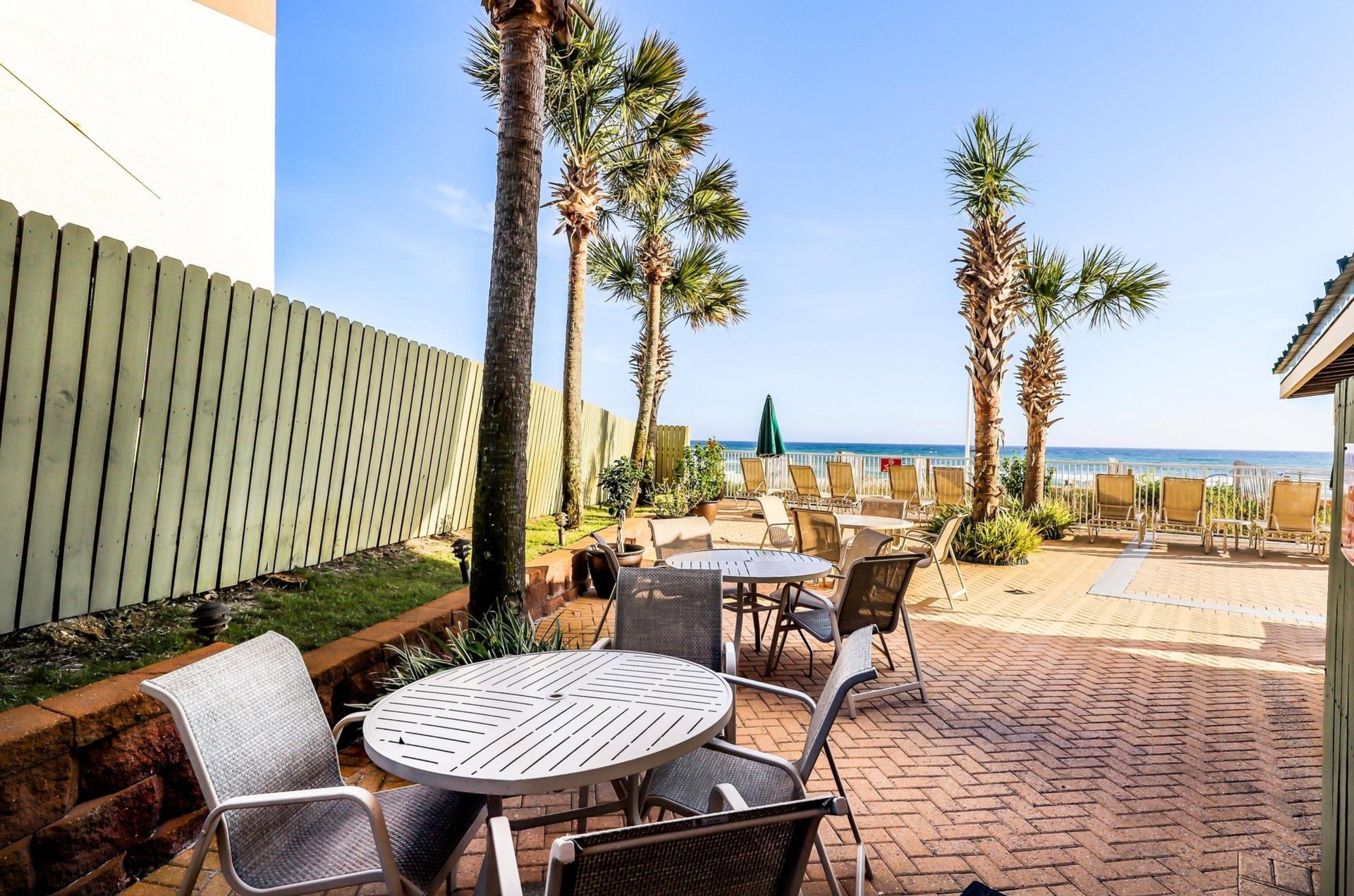 The waterfront patio with lounge chair and tables