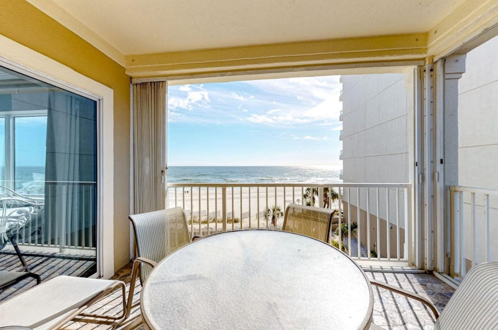 A private balcony with dining chairs and table at Marlin Key in Orange Beach Alabama