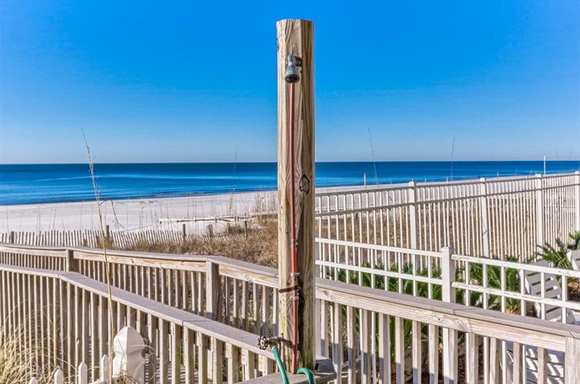 The outdoor shower on the boardwalk at Romar Tower in Orange Beach Alabama