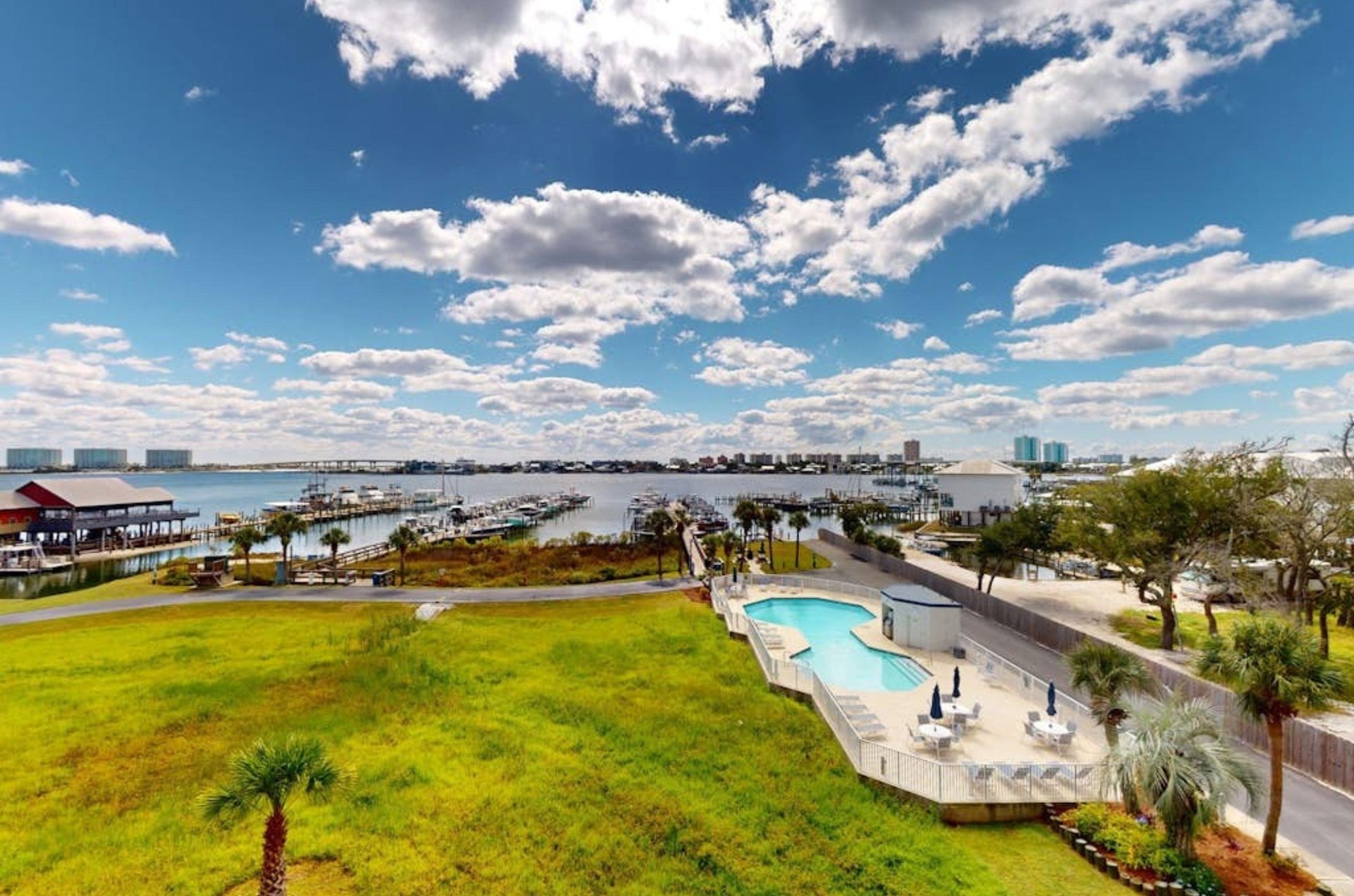 View from a balcony of the outdoor pool and the wooden piers on Terry Cove