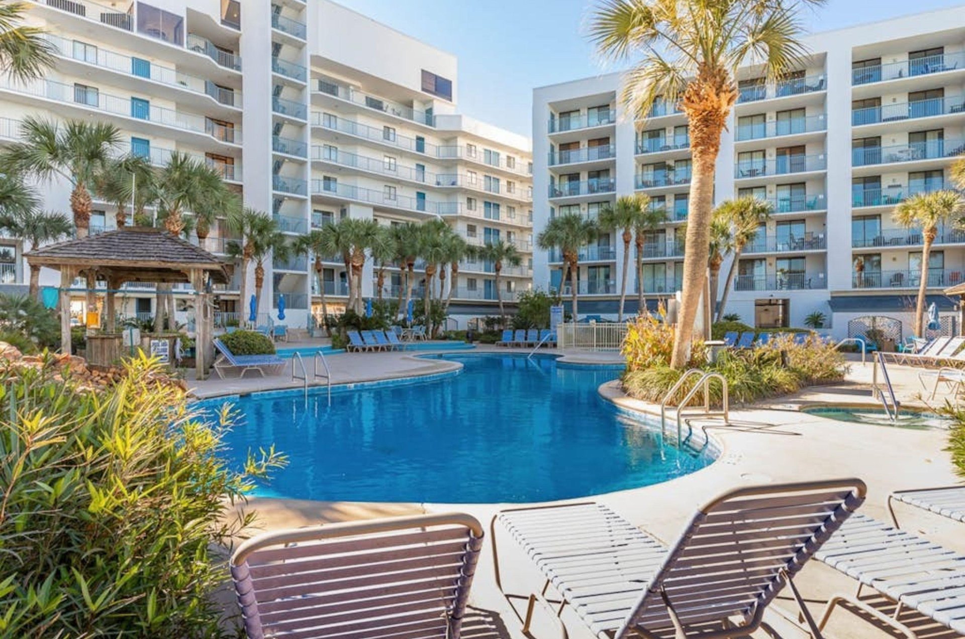 Lounge chairs by the clovershaped swimming pool at Gulf Shores Surf and Racquet Club in Gulf Shores Alabama