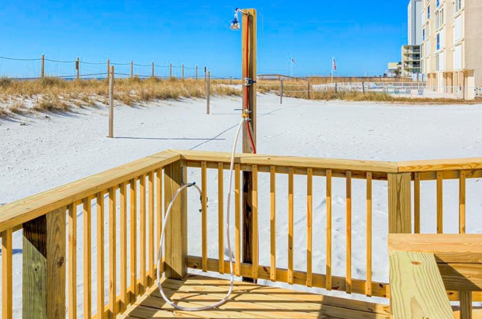 The outdoor shower on the wooden boardwalk at Edgewater East in Gulf Shores Alabama