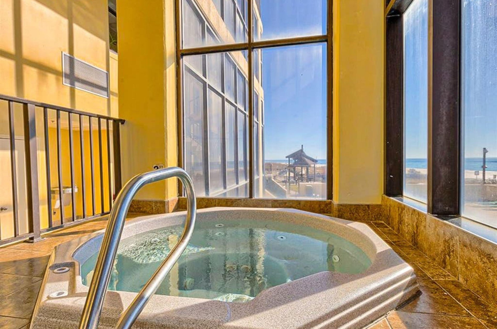 The indoor hot tub next to windows at Phoenix I in Orange Beach Alabama