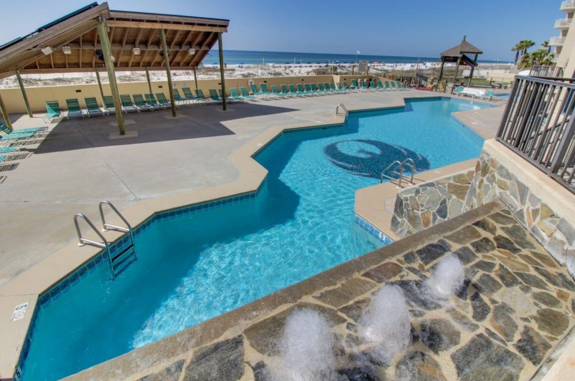 Overhead view of the long outdoor swimming pool at Phoenix I in Orange Beach Alabama