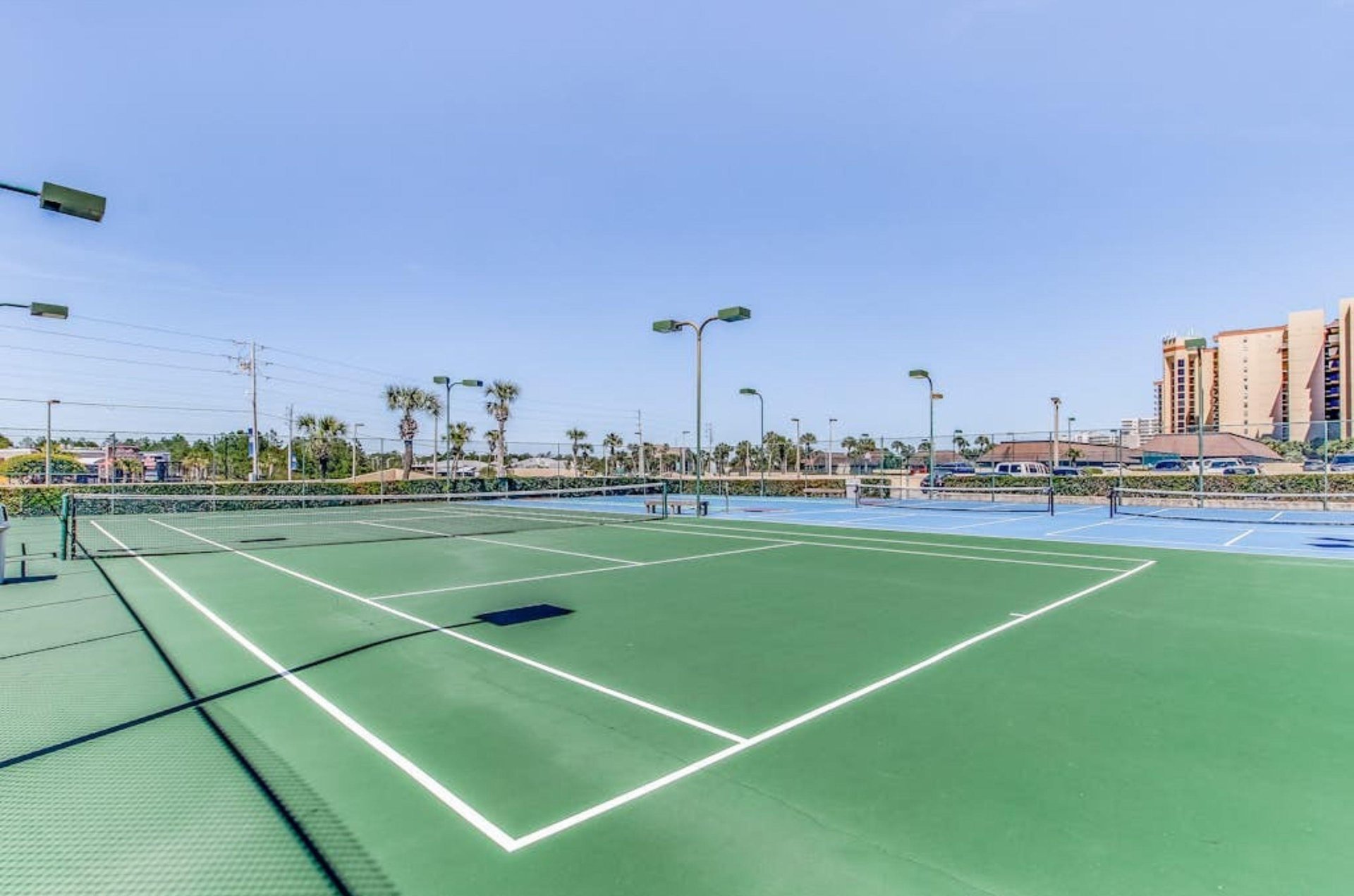 The outdoor tennis courts at Phoenix III in Orange Beach Alabama