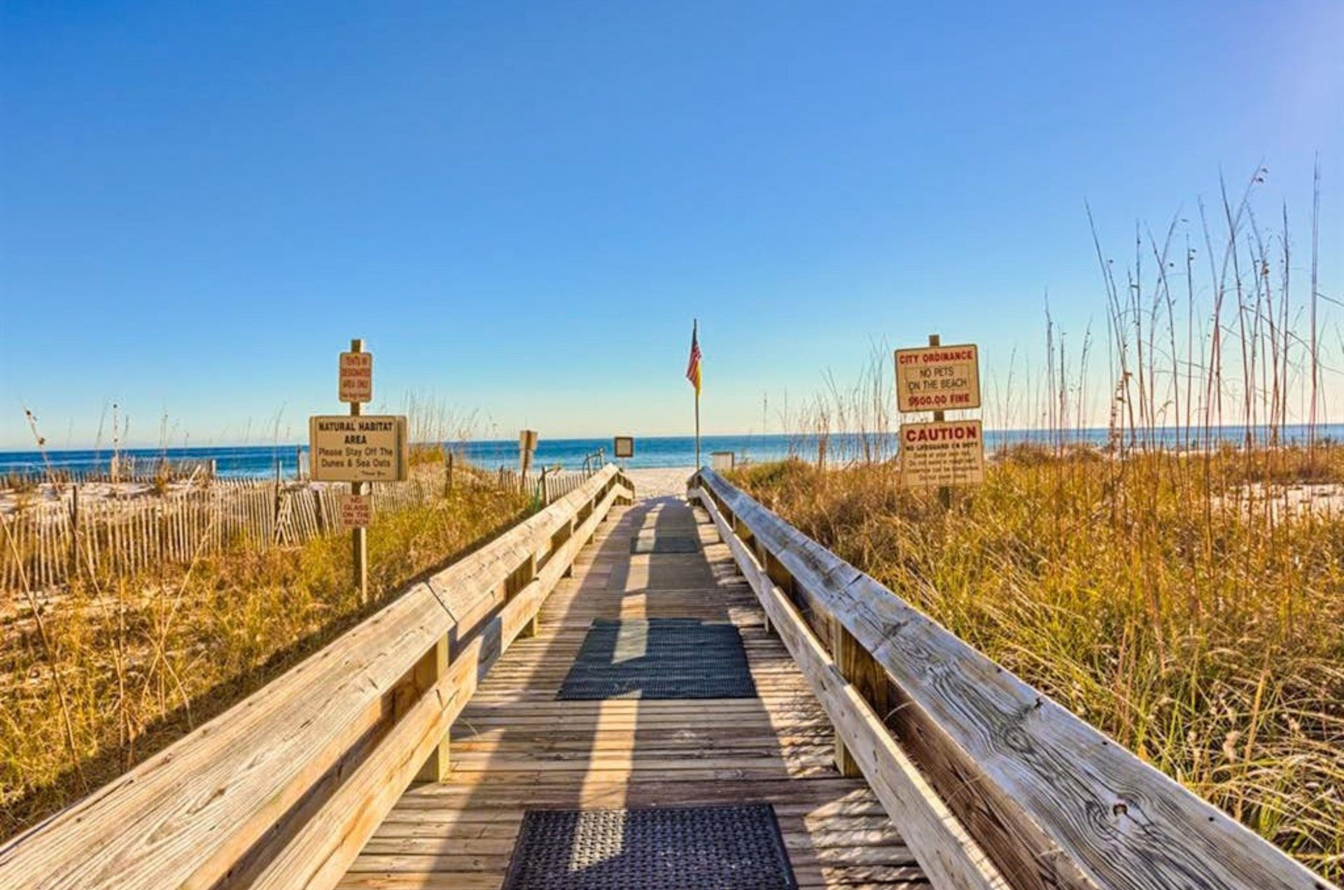 A wooden boardwalk leading to the Gulf at Phoenix III in Orange Beach Alabama
