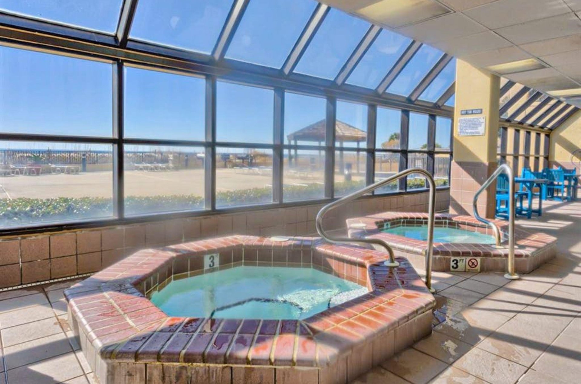 The indoor hot tubs overlooking the beach at Phoenix V in Orange Beach Alabama
