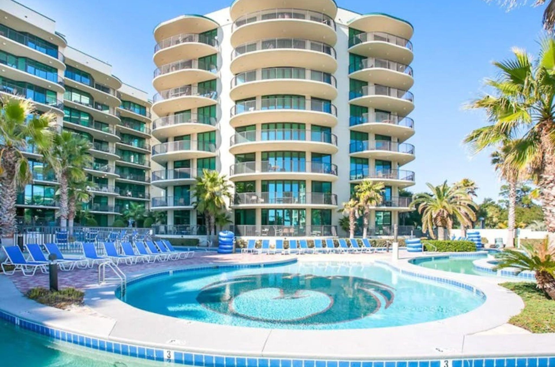 An outdoor pool and lazy river in front of Phoenix on the Bay in Orange Beach Alabama
