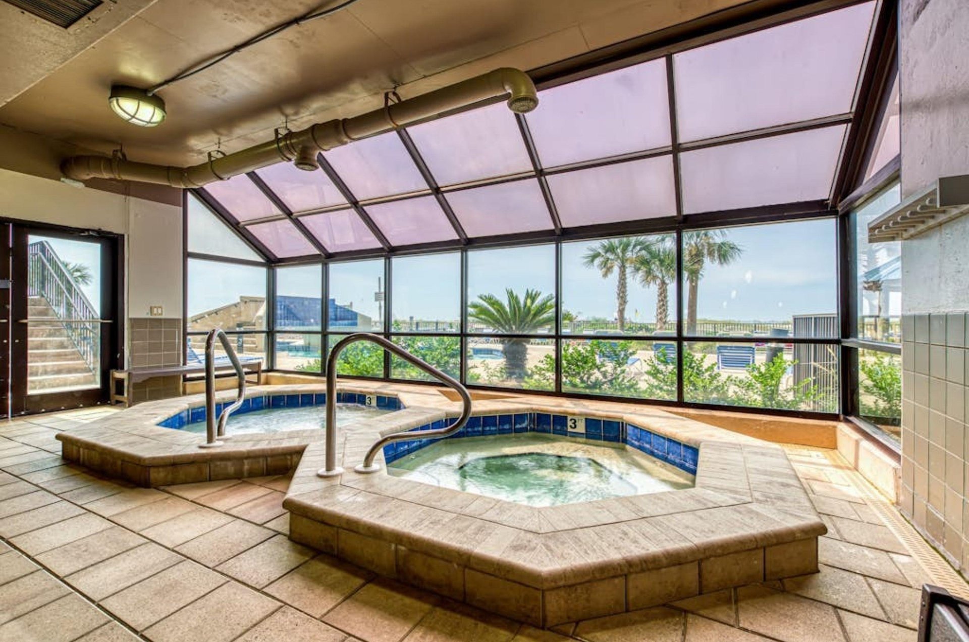 The indoor hot tubs next to windows at Phoenix on the Bay in Orange Beach Alabama